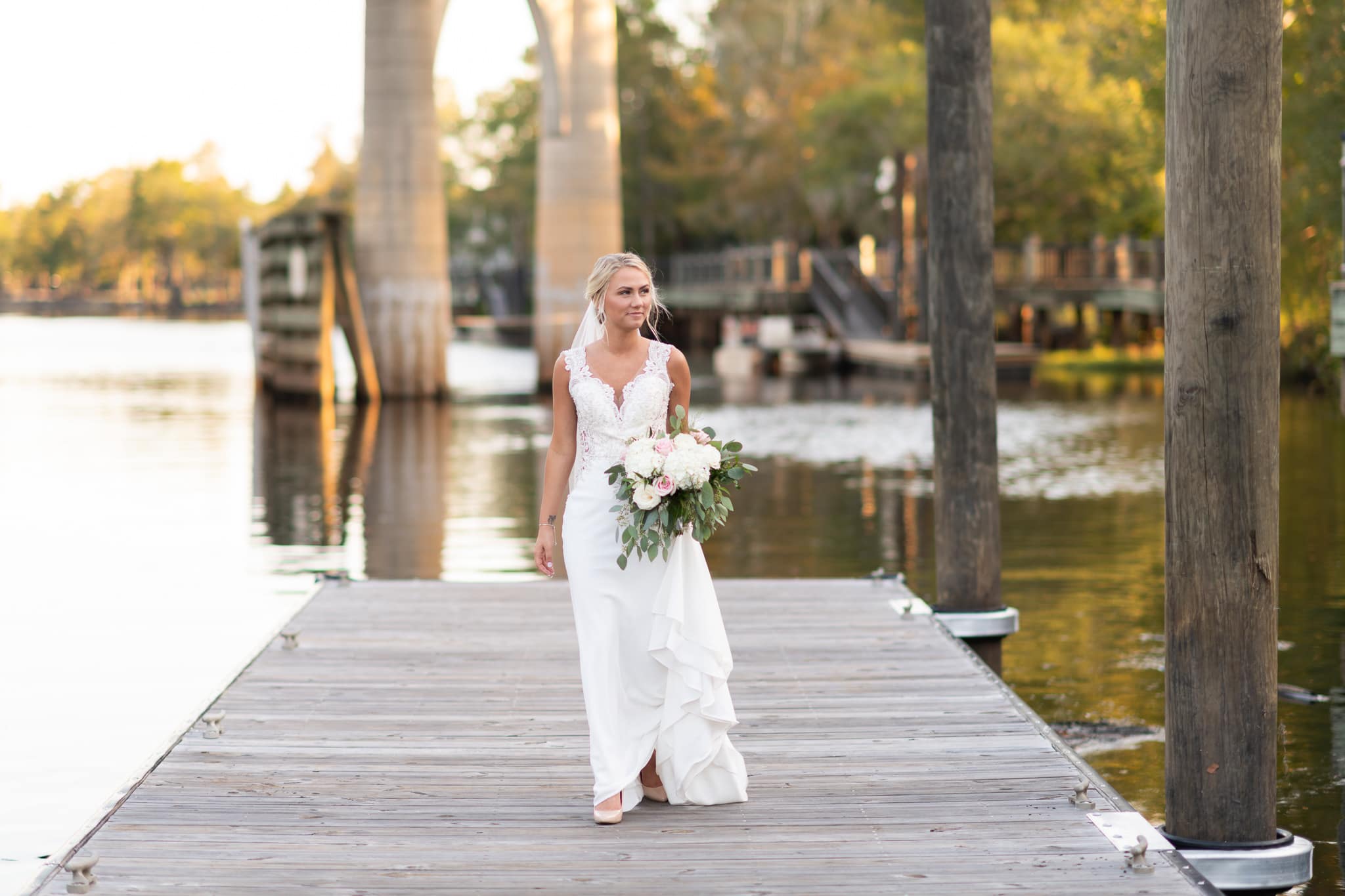 Bride walking down the road dock - Conway River Walk