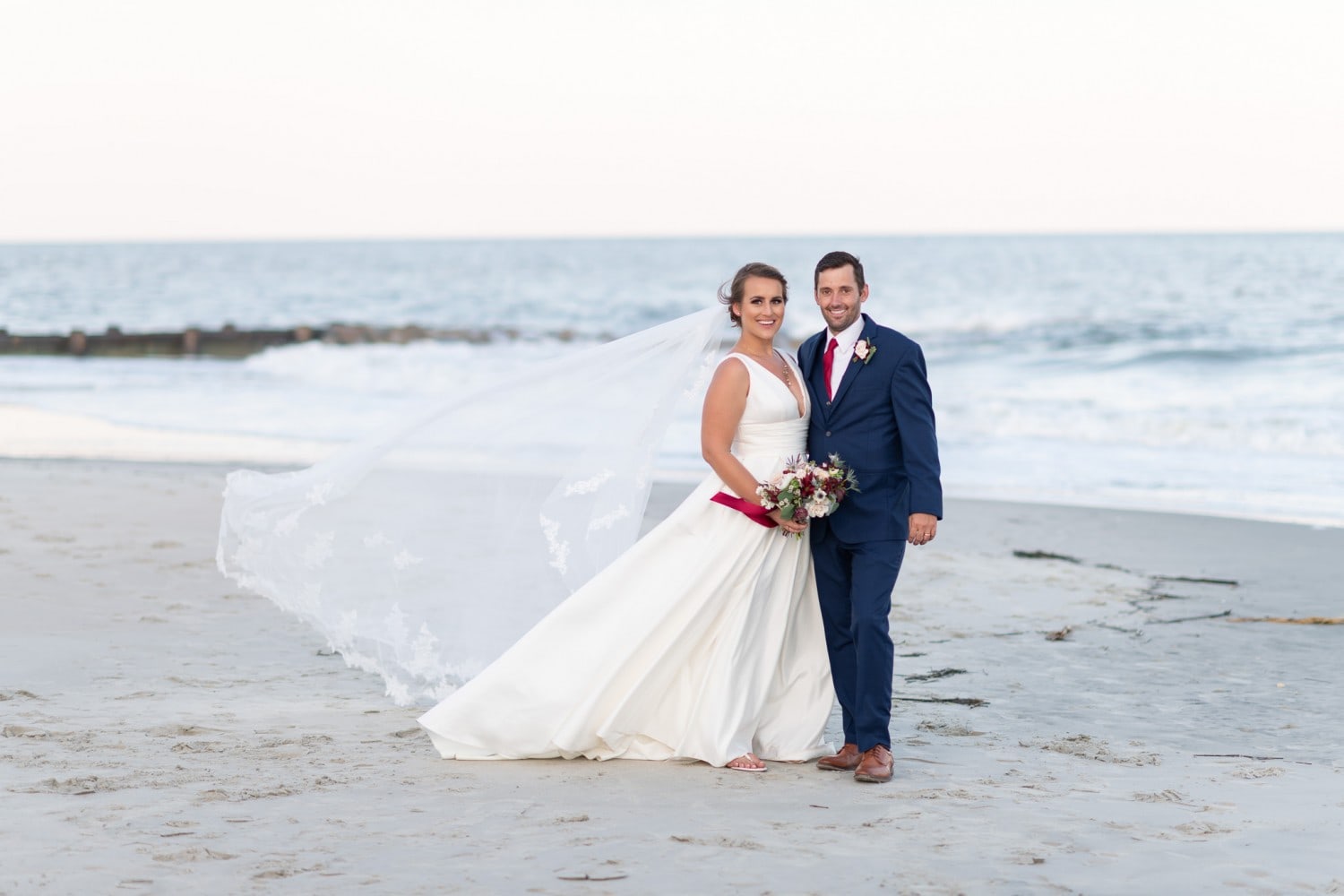 Bride and groom with her veil blowing in the wind - Pelican Inn - Pawleys Island