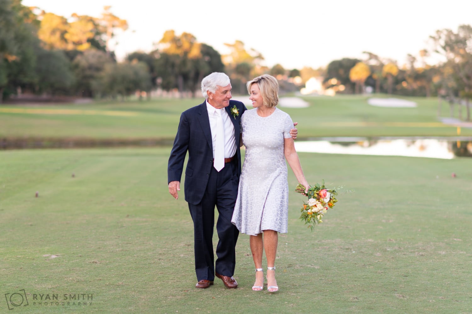 Bride and groom walking together down the golf course - Dunes Golf and Beach Club - Myrtle Beach