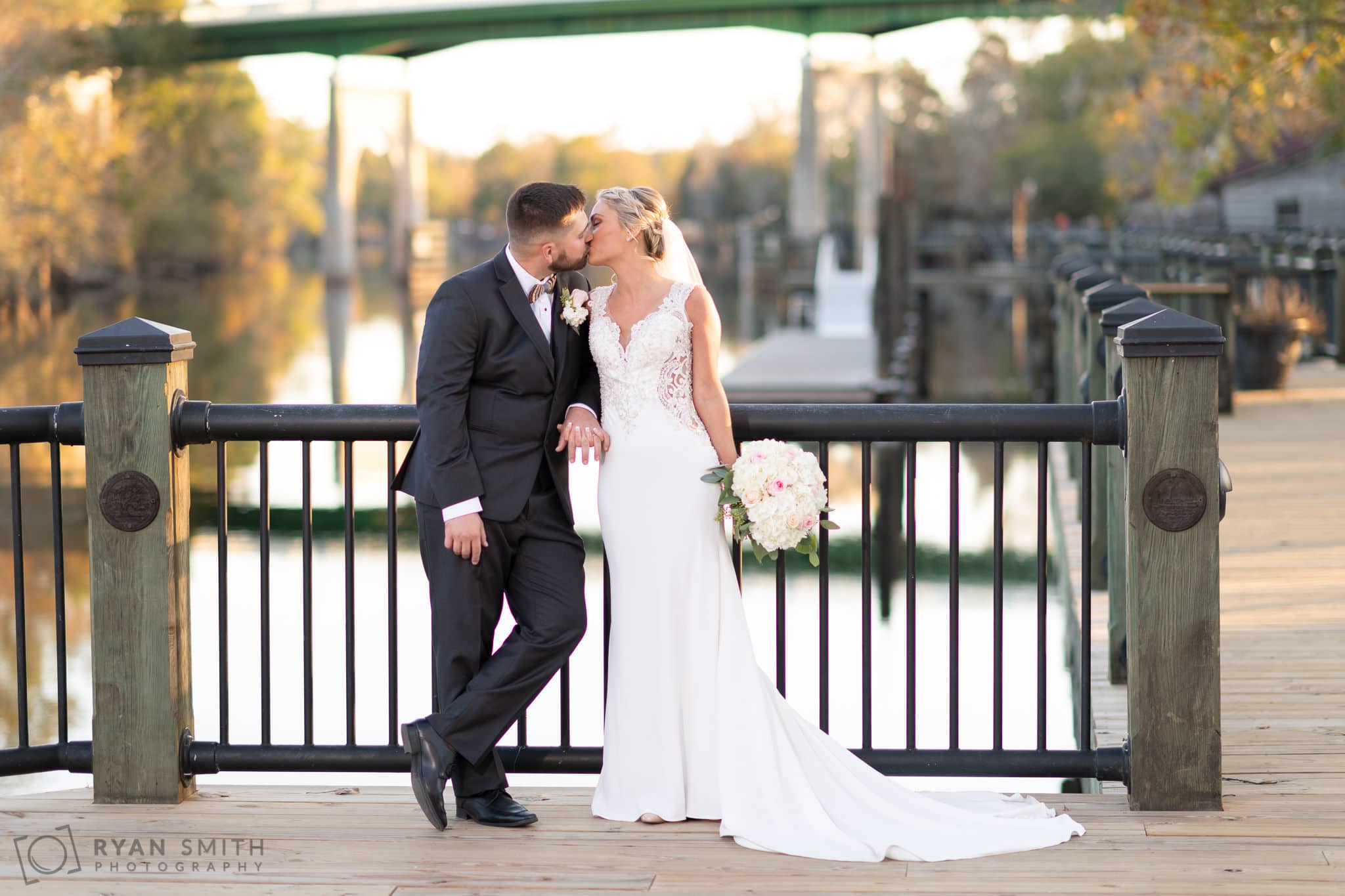 Casual portrait of bride and groom with old Conway bridge in the background - Conway River Walk