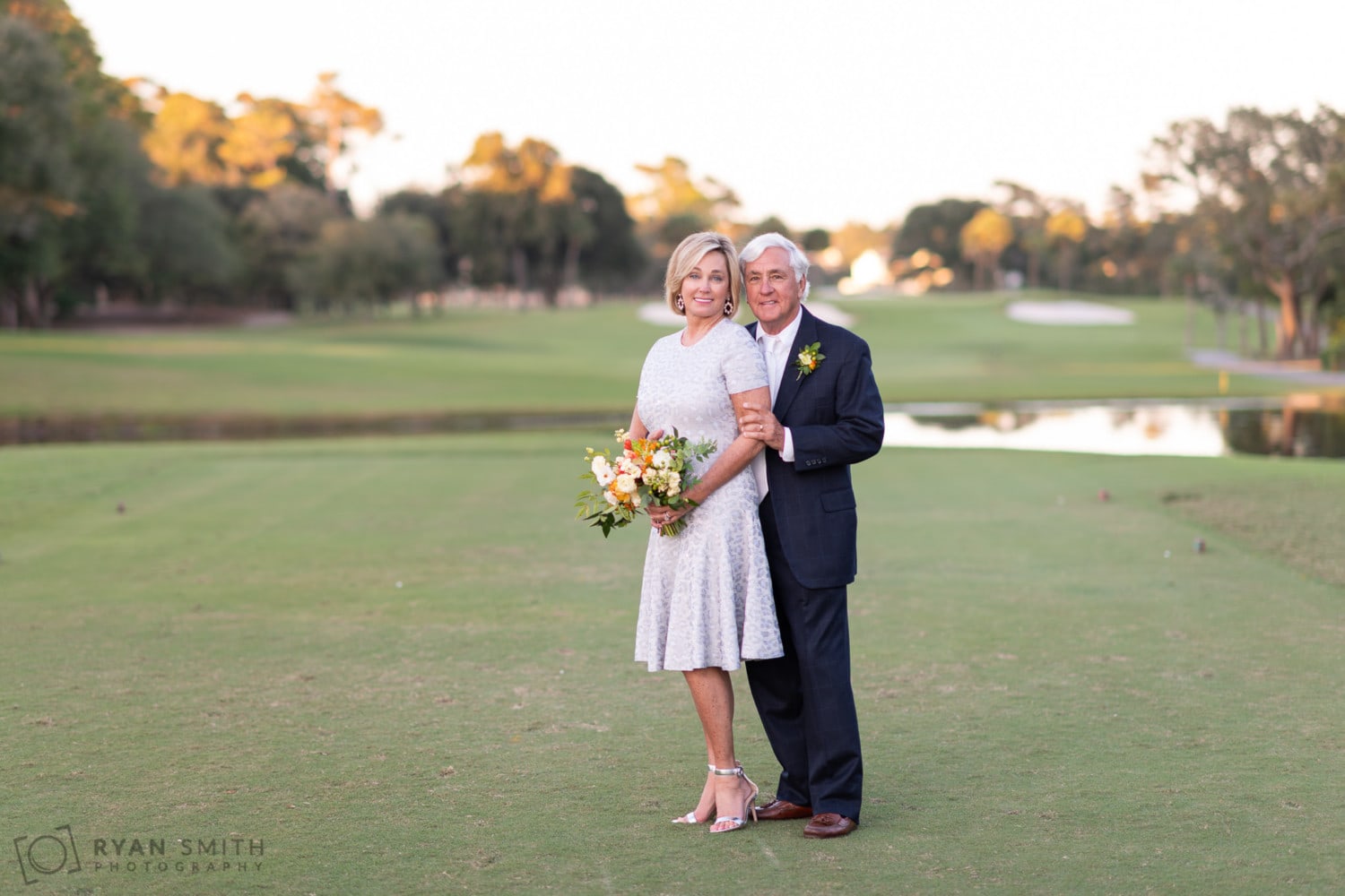 Groom standing behind the bride on the golf course - Dunes Golf and Beach Club - Myrtle Beach