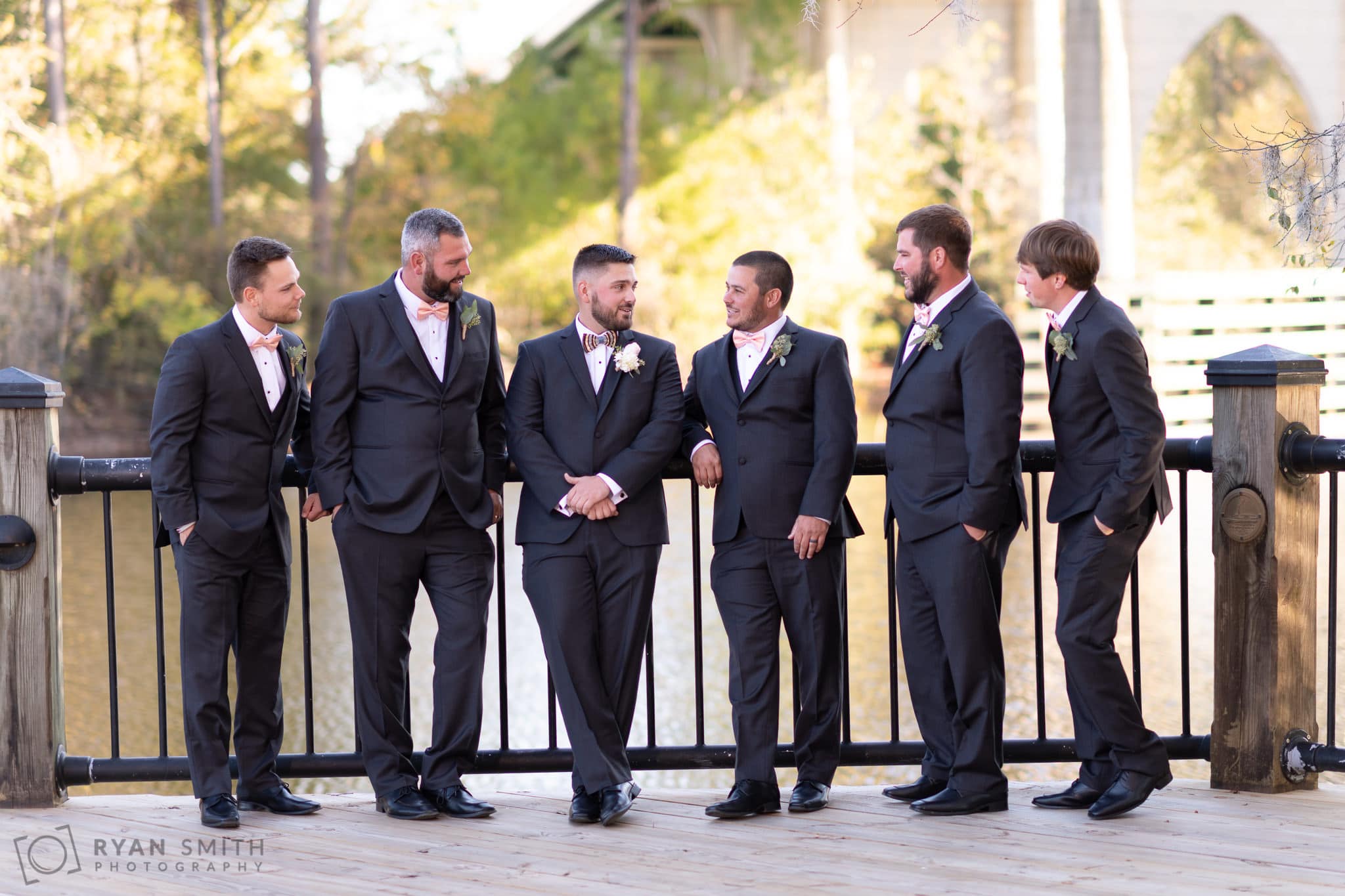 Groomsmen talking to each other by the river - Conway River Walk