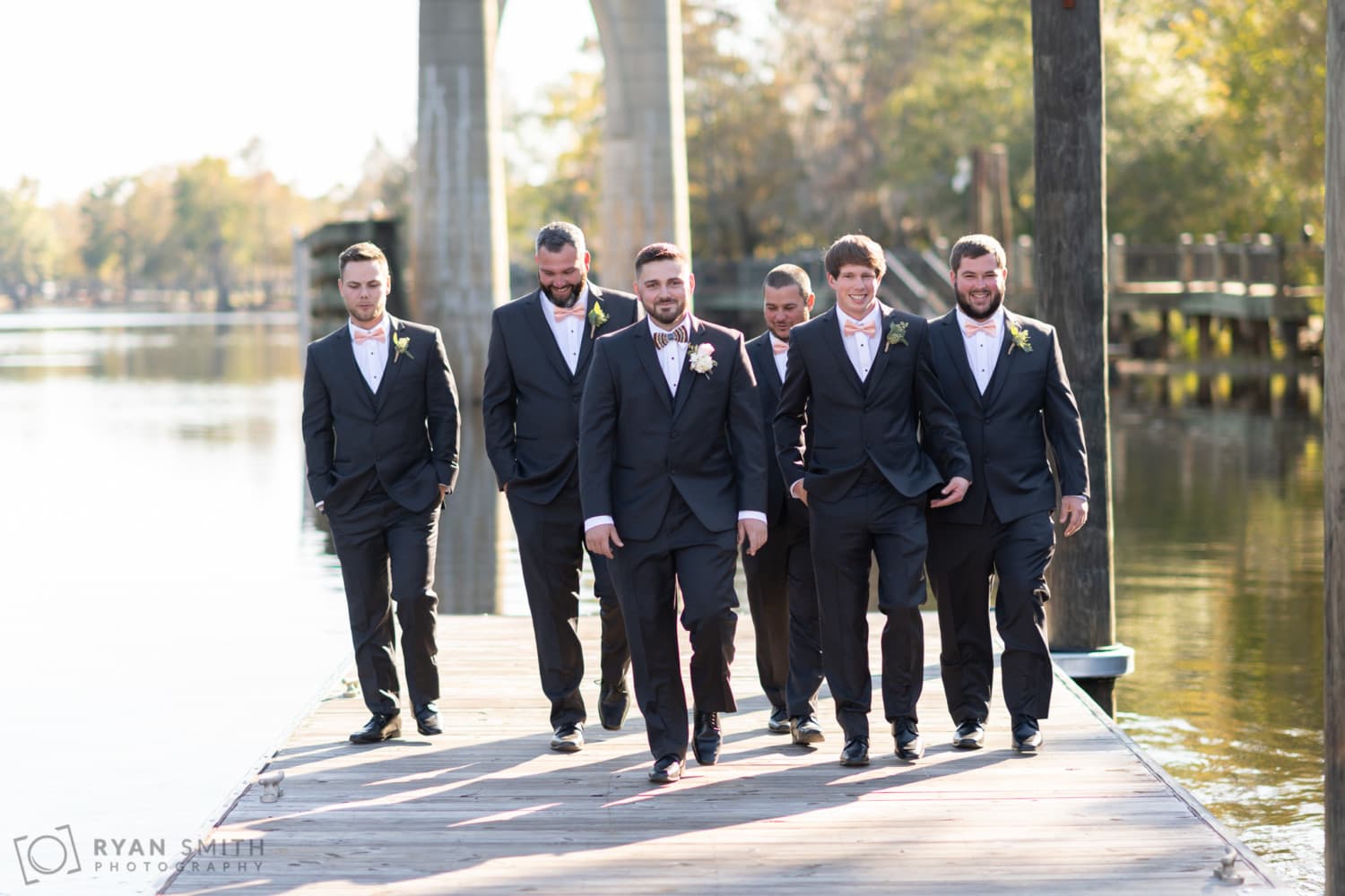 Groomsmen walking down the dock together - Conway River Walk