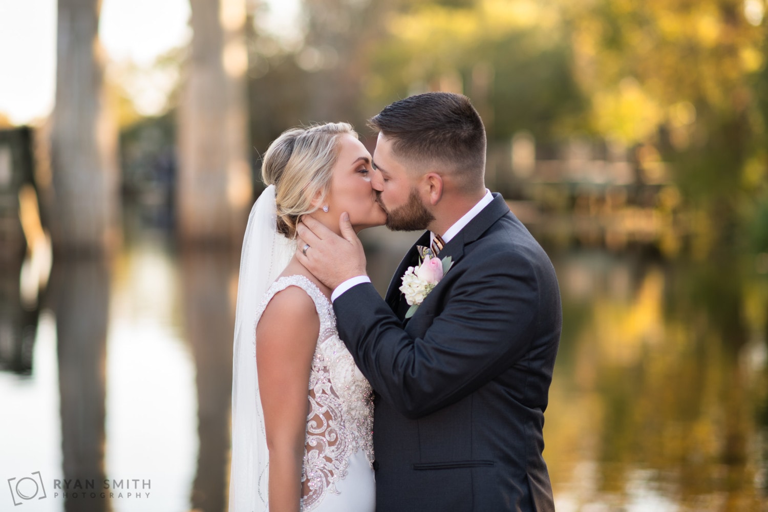 Intimate kiss with the Waccamaw River in the background - Conway River Walk