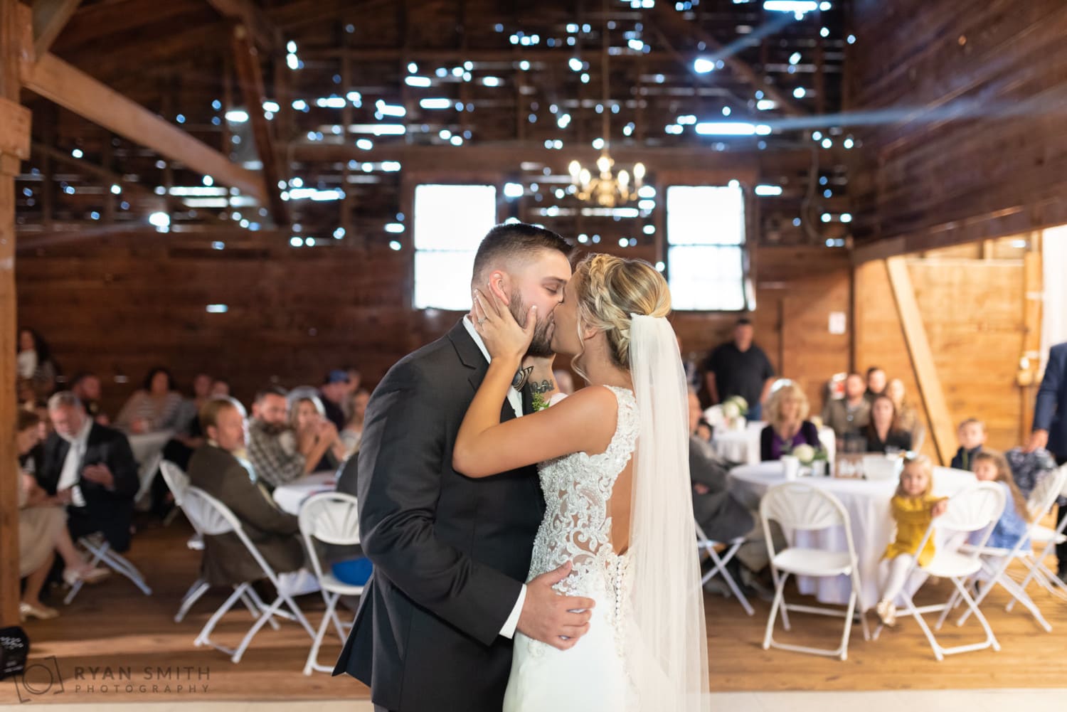 Kiss on the dance floor with sunlight filtering through the wall - Peanut Warehouse - Conway