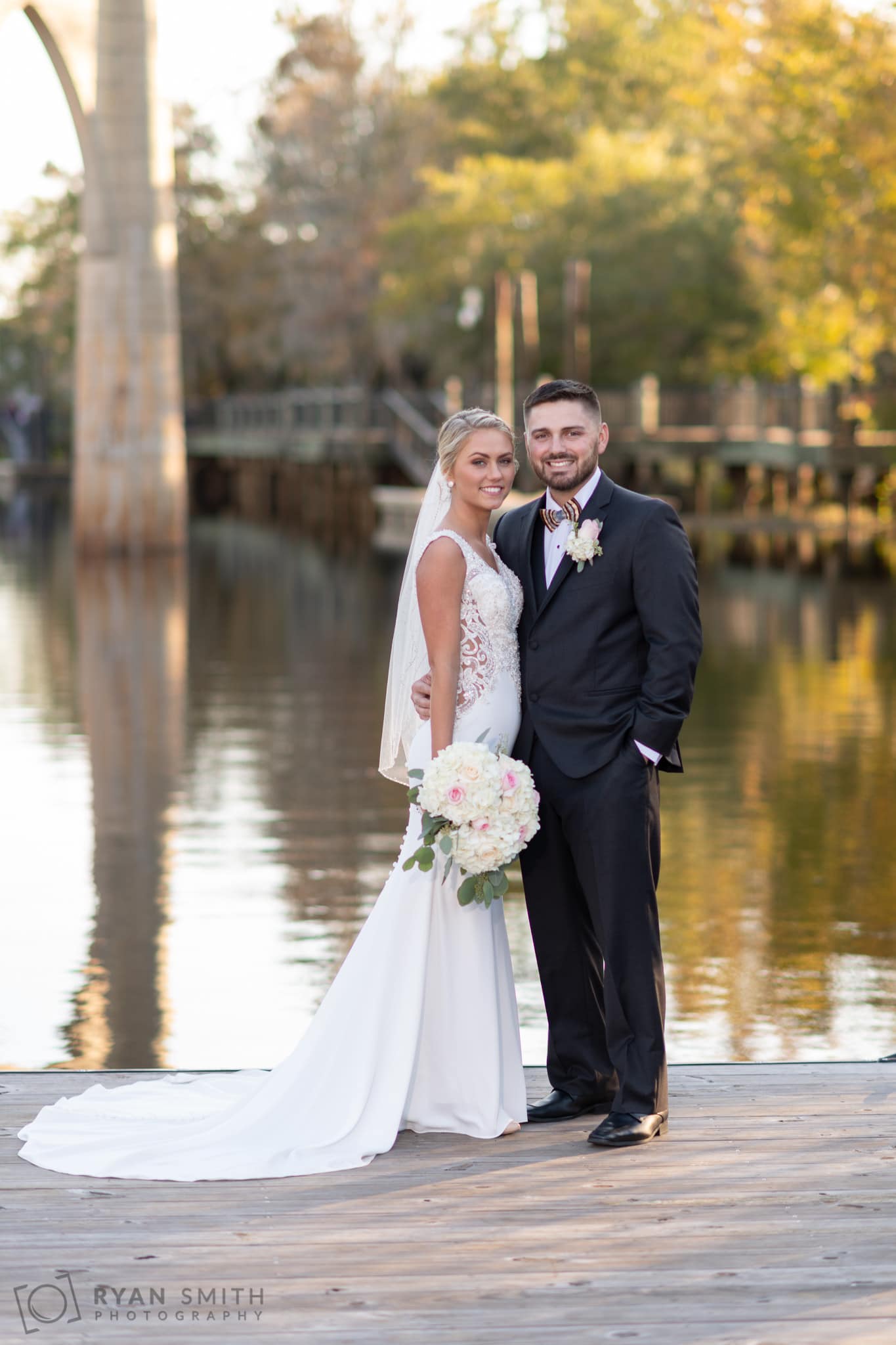 Portraits of the bride and groom on Waccamaw River rock - Conway River Walk