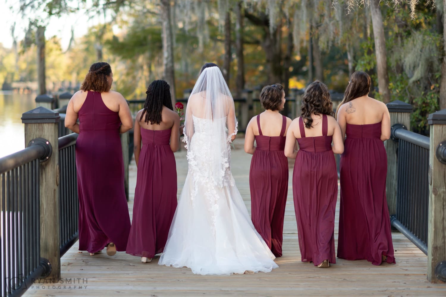 Bridesmaids walking down the boardwalk - Conway River Walk