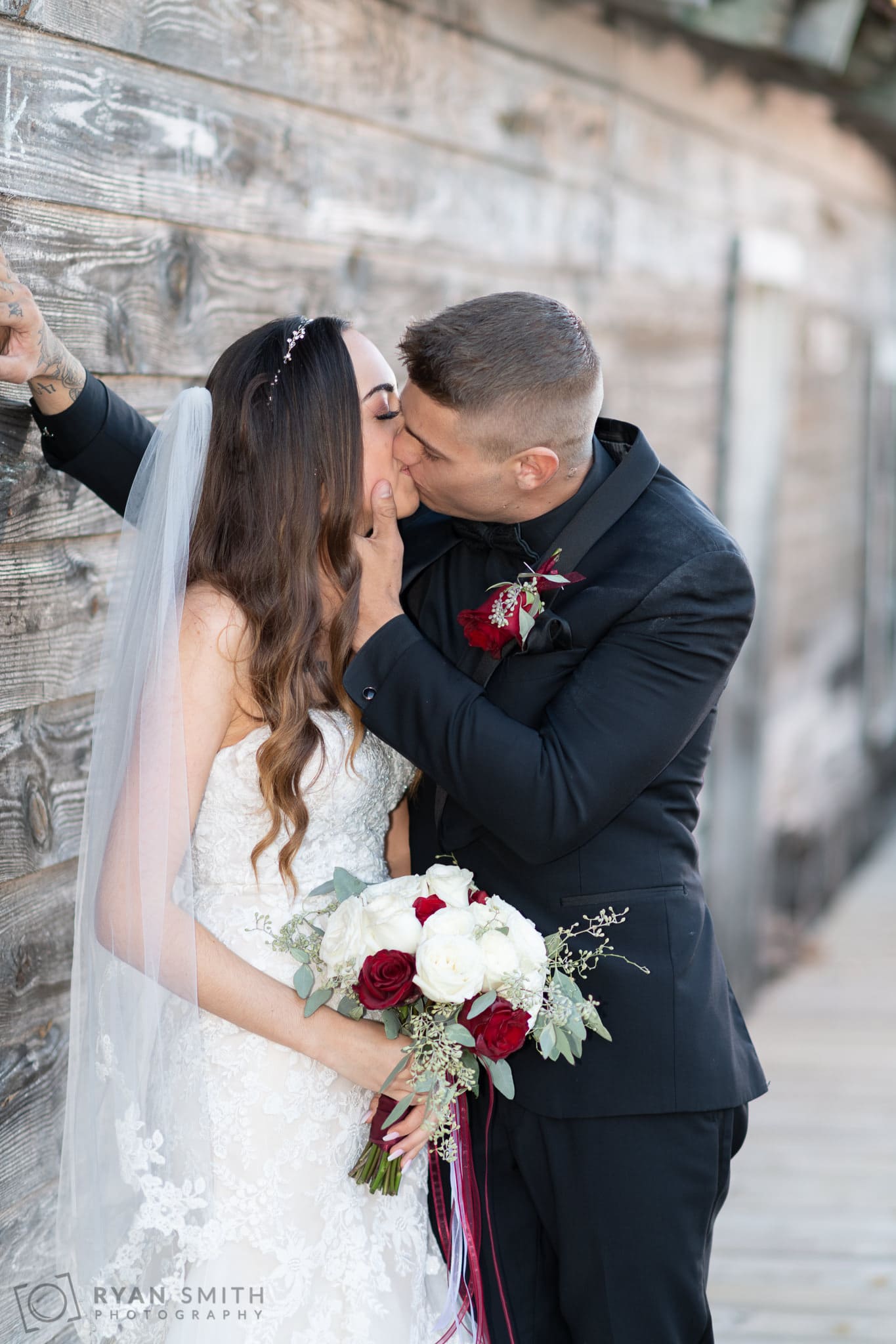 Kiss against the old wall on the Riverwalk -