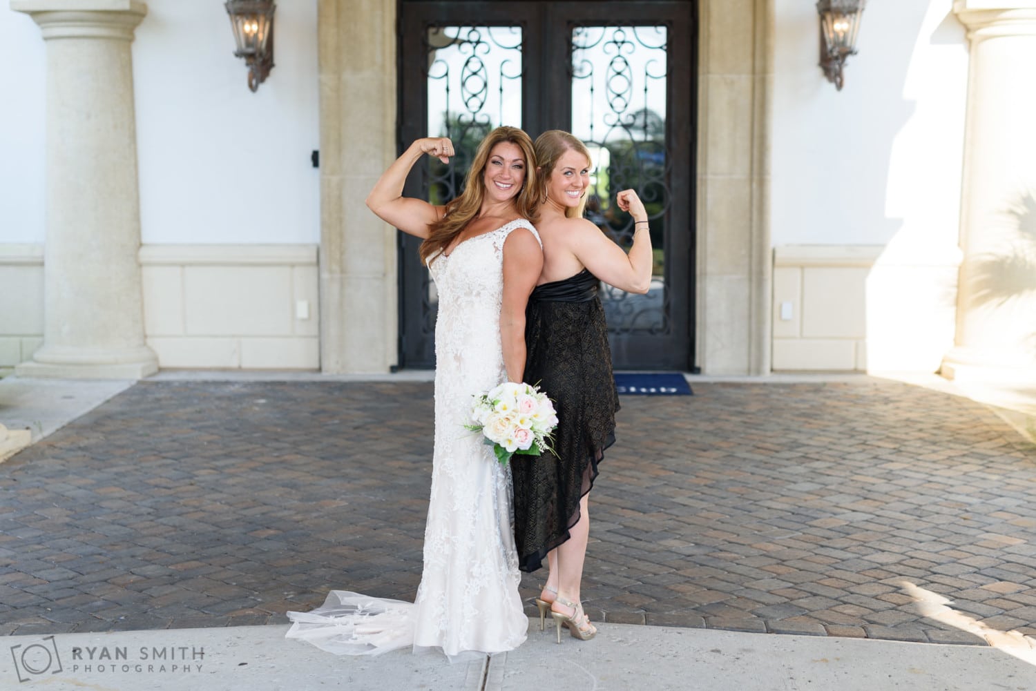 Bride and best friend showing off their muscles - Members Club at Grande Dunes