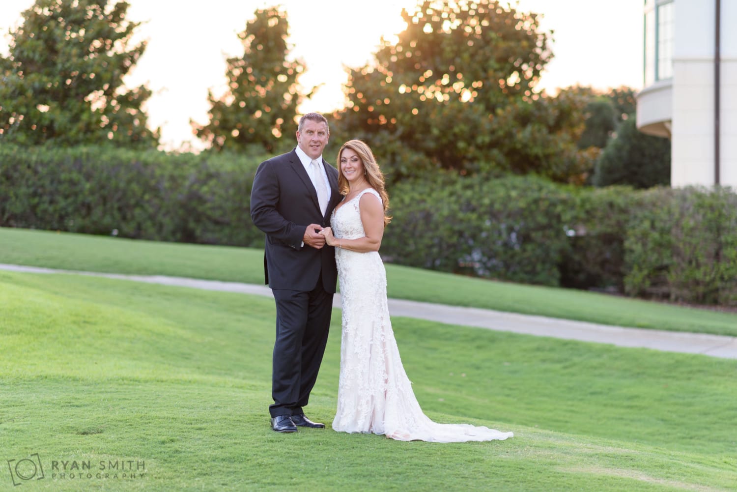 Bride and groom holding hands in the unset - Members Club at Grande Dunes