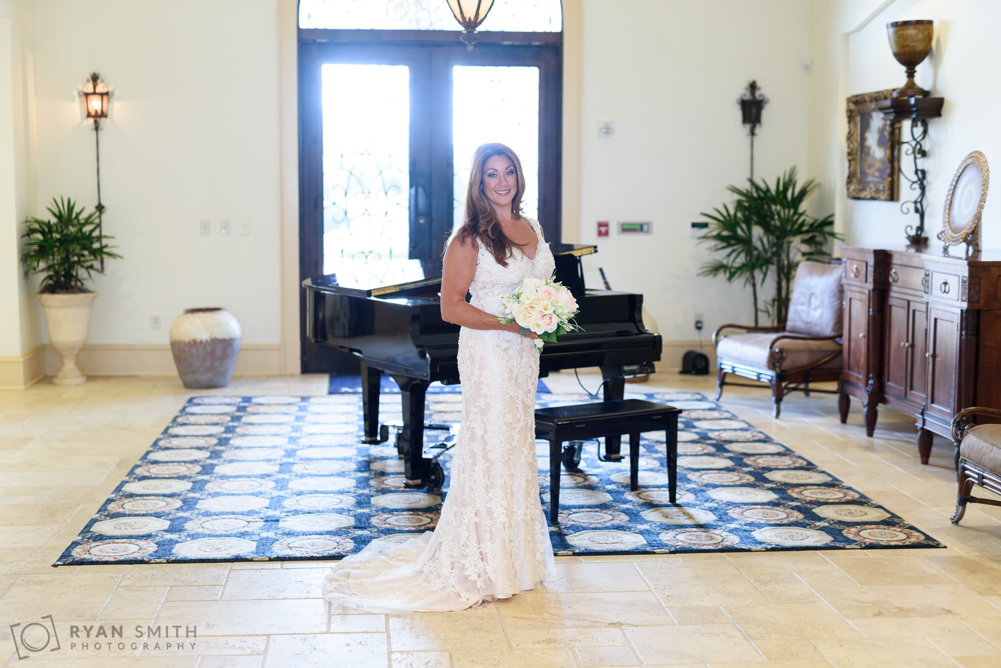 Bride standing in front of the grand piano - Members Club at Grande Dunes