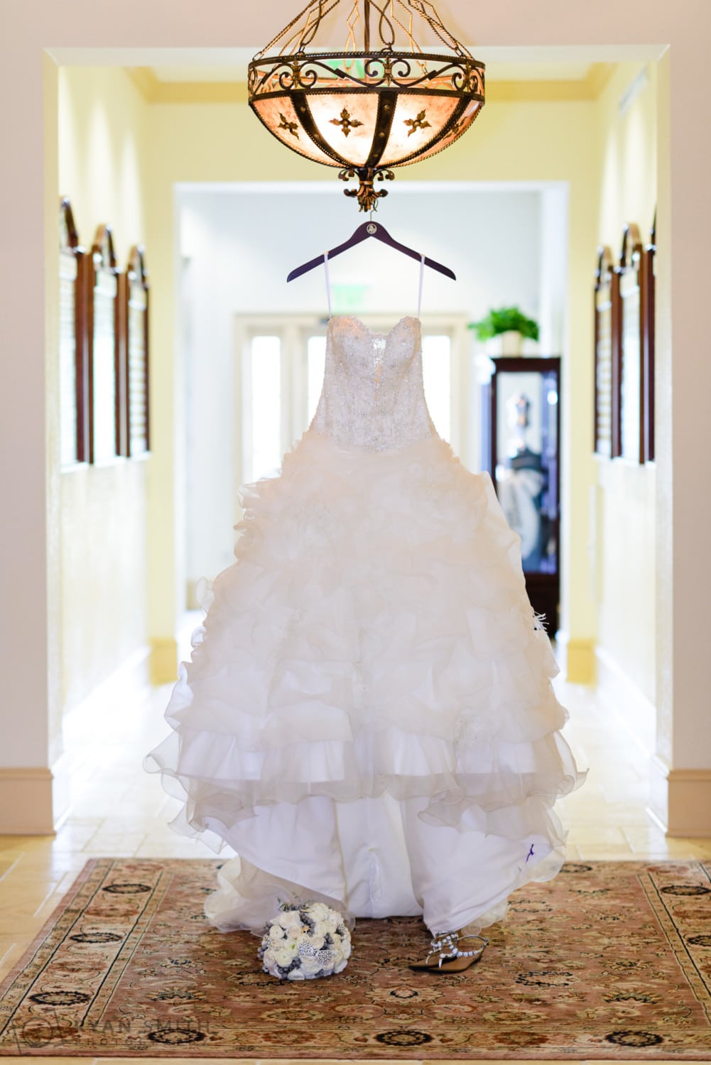 Bride's dress hanging in the hallway - Members Club at Grande Dunes