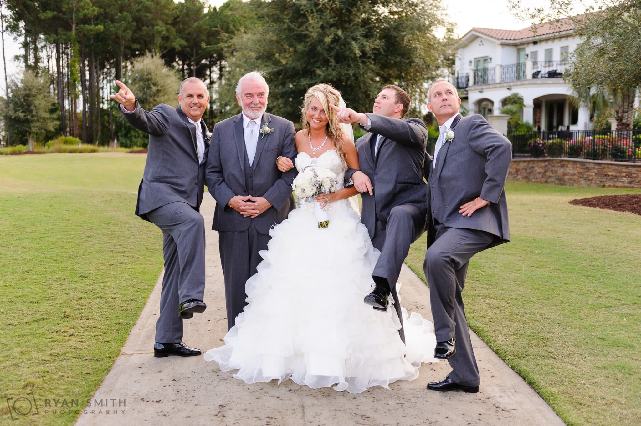 Silly pose with the groomsmen and bride - Members Club at Grande Dunes