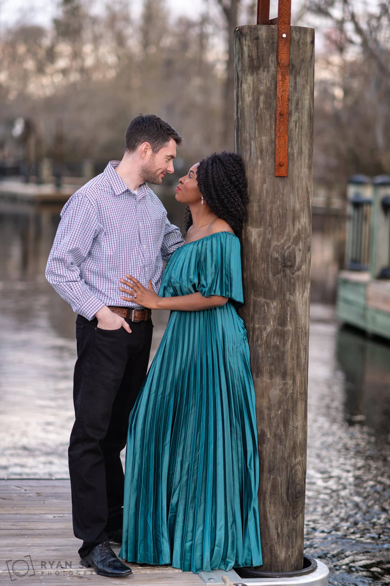 Anniversary portraits leaning against the river dock - Conway Riverwalk