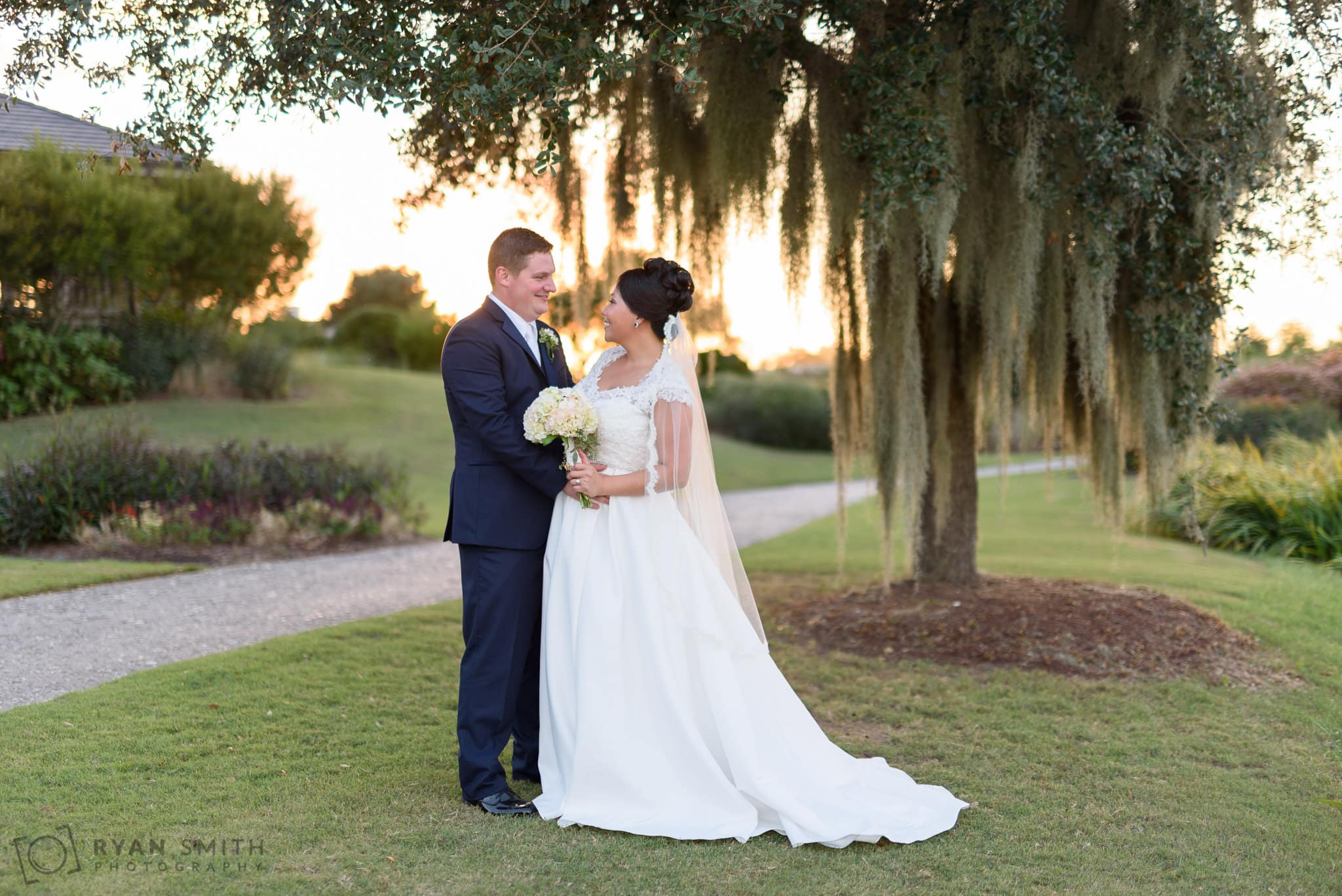Bride and groom backlit by the sunset - Dye Club at Barefoot Resort