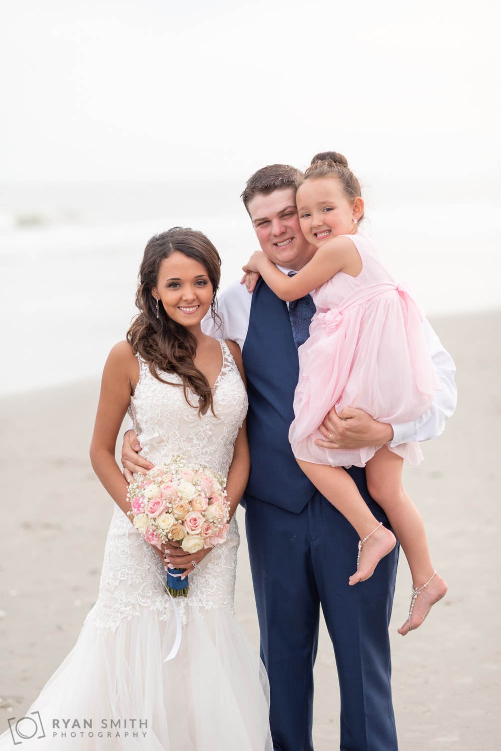 Bride and groom holding daughter - Avista Resort - North Myrtle Beach