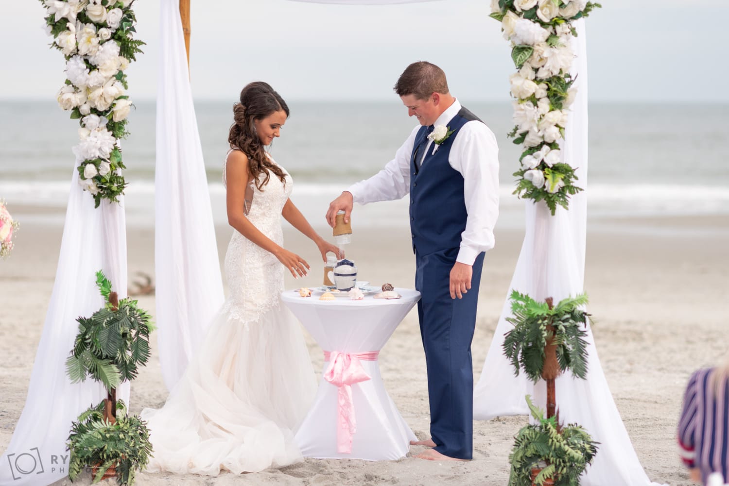 Bride and groom pouring in the sand - Avista Resort - North Myrtle Beach