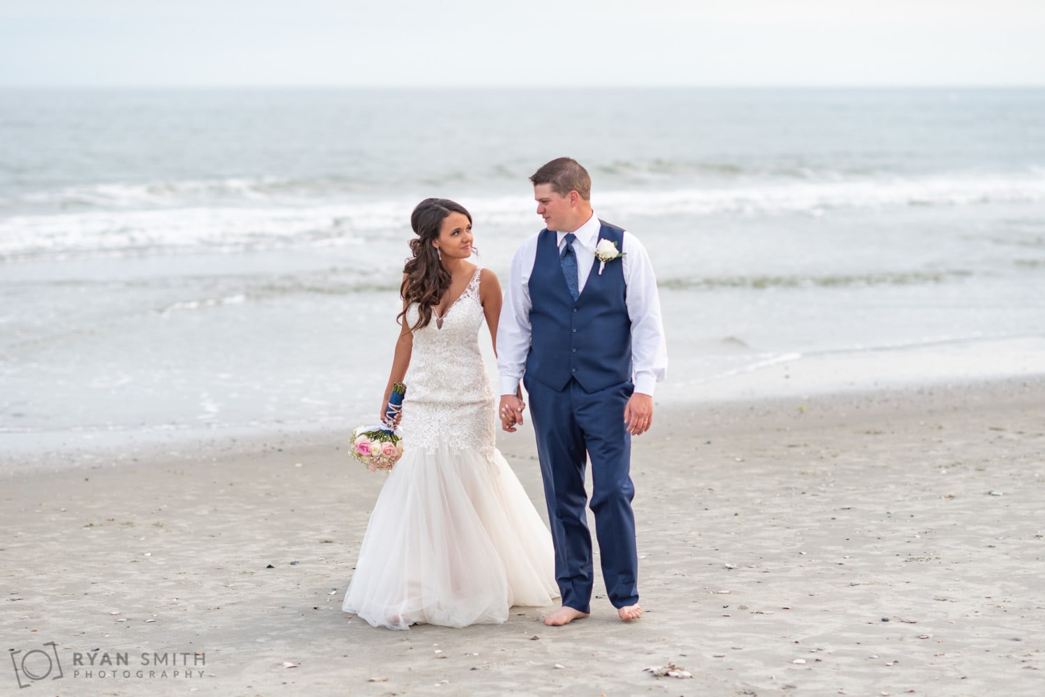 Bride and groom walking down the beach - Avista Resort - North Myrtle Beach