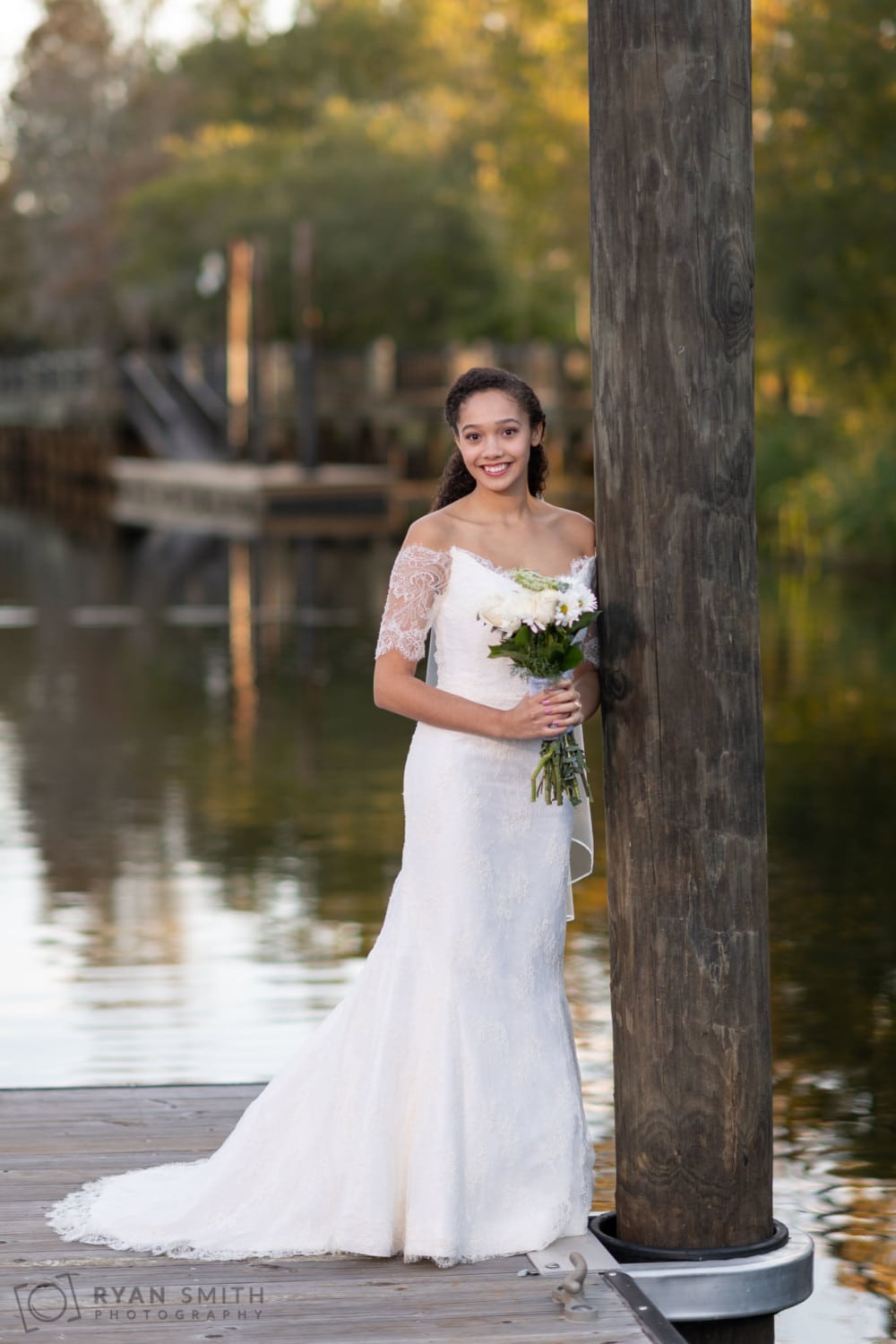 Bride leaning against the dock - Conway Riverwalk