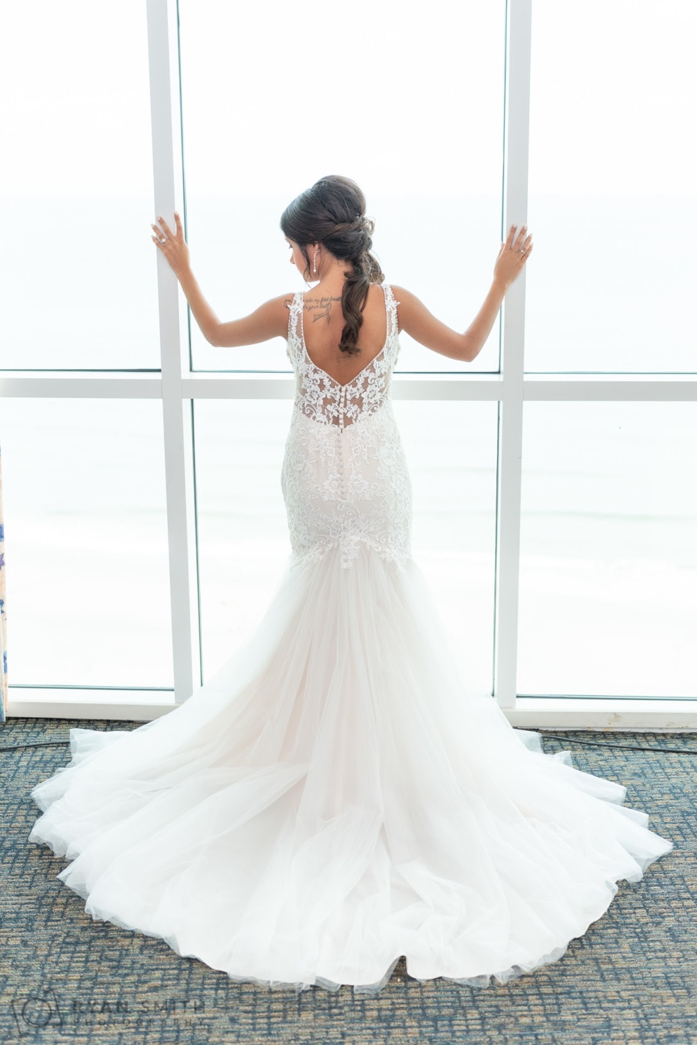 Bride looking out of the window - Avista Resort - North Myrtle Beach