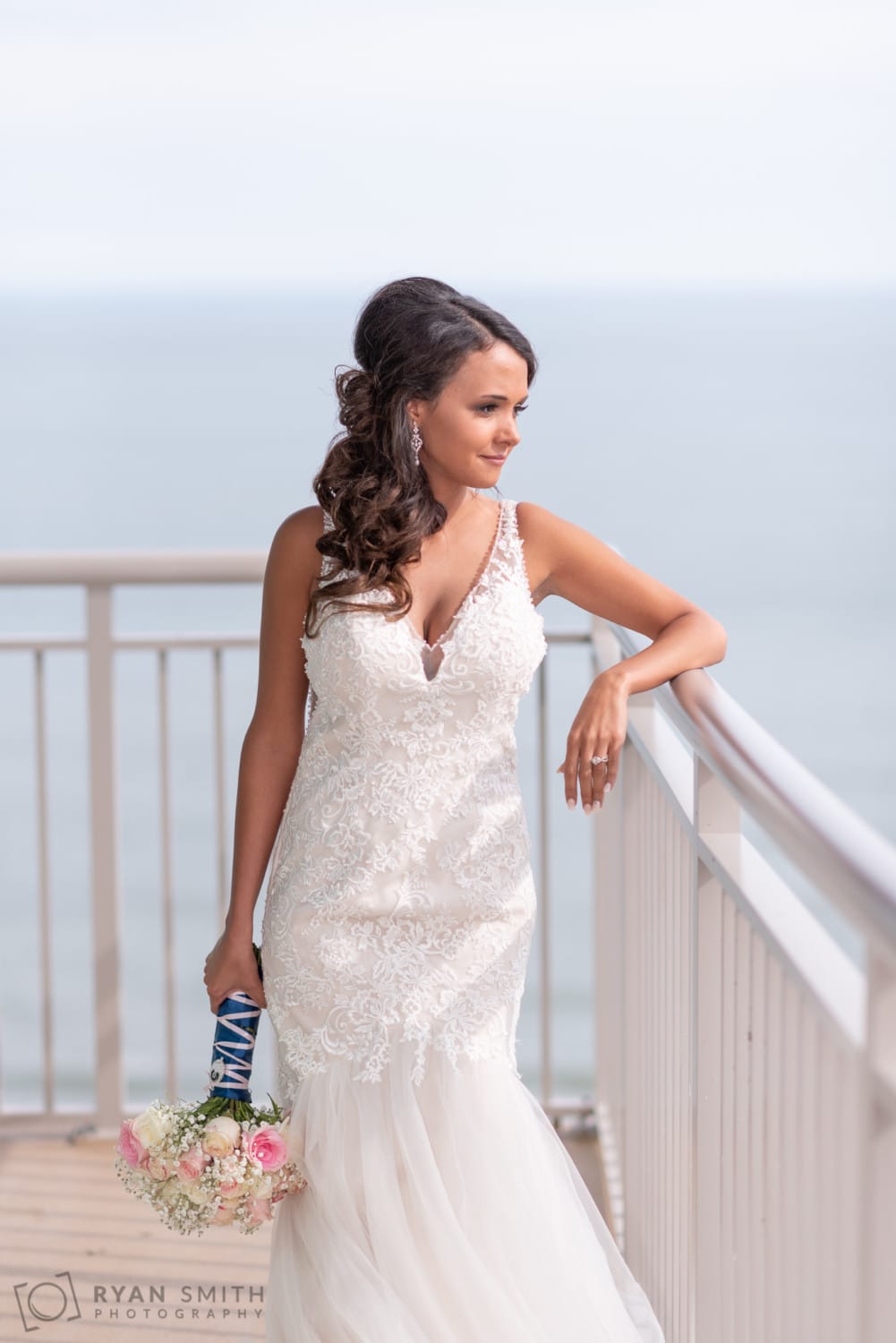 Bride looking out over the balcony - Avista Resort - North Myrtle Beach