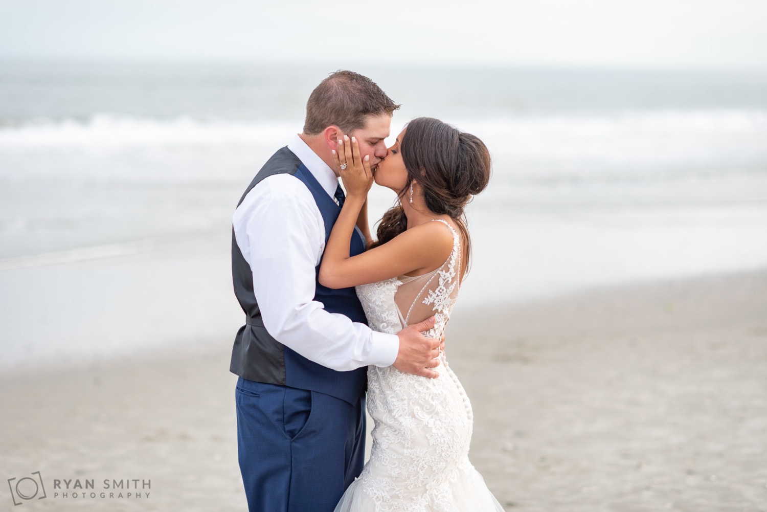 Bride pulling her husband in for a kiss - Avista Resort - North Myrtle Beach