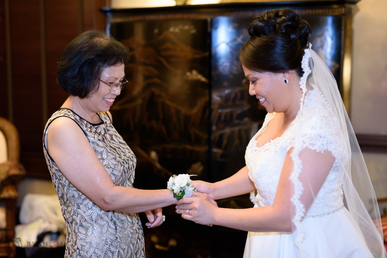 Bride putting corsage on her mom - Dye Club at Barefoot Resort