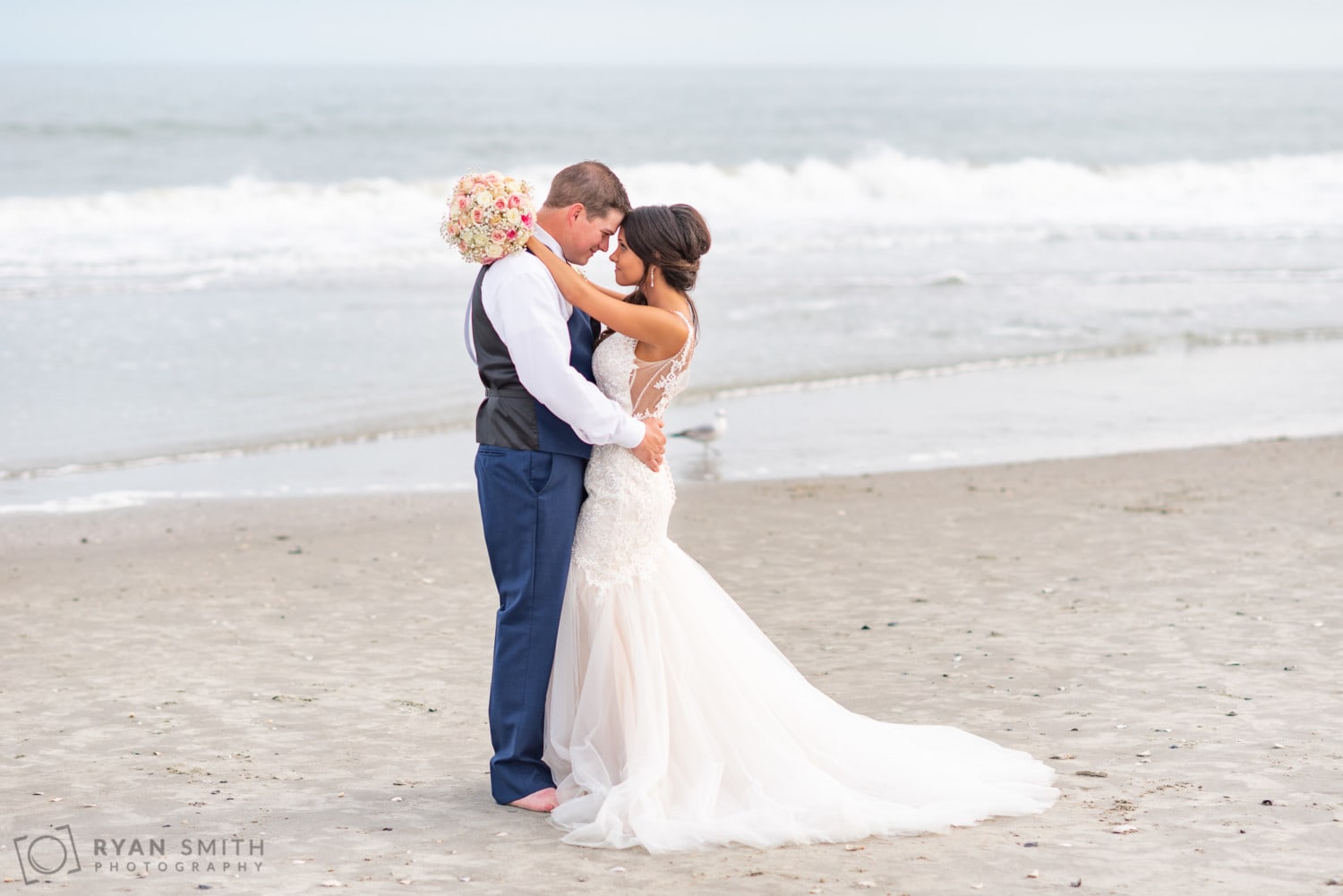 Bride with her arms around the groom holding her bouquet - Avista Resort - North Myrtle Beach
