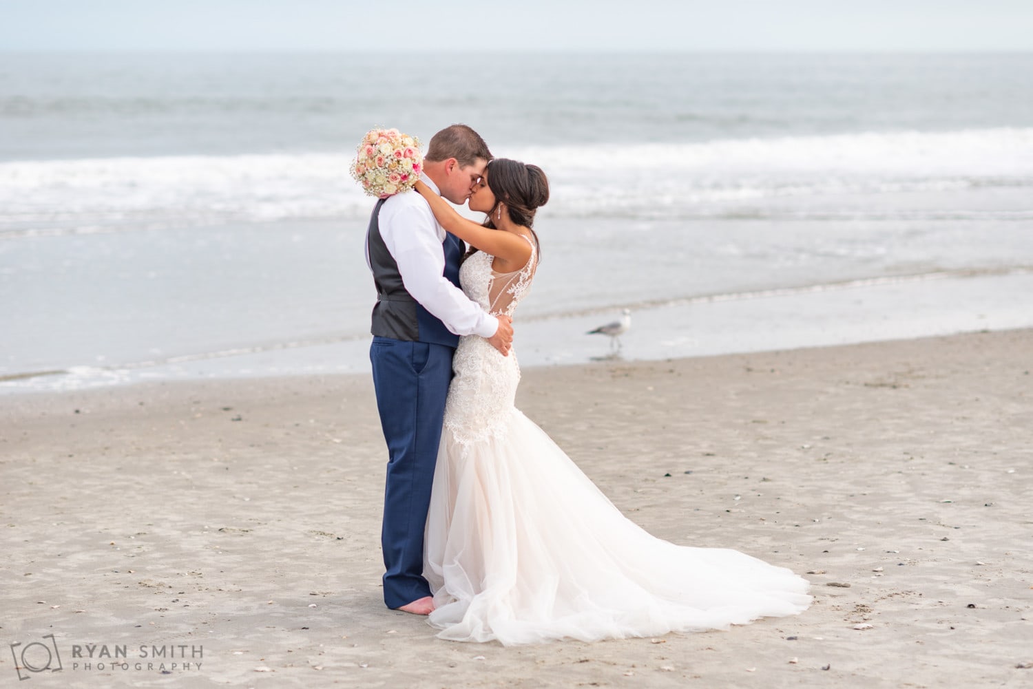 Bride with her arms around the groom holding her bouquet - Avista Resort - North Myrtle Beach