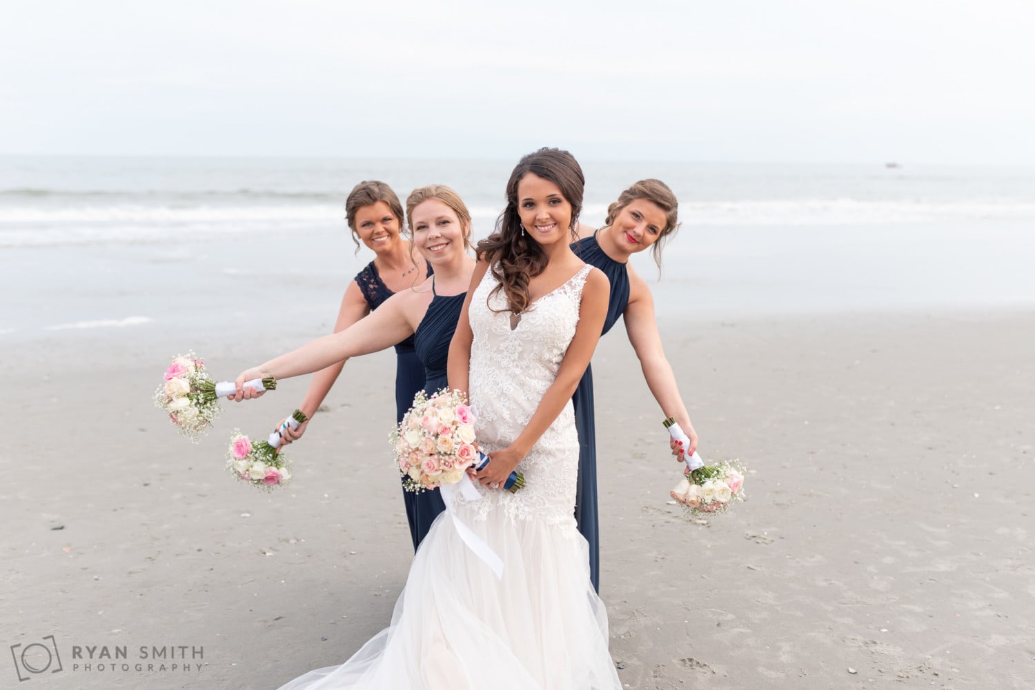 Bridesmaids peaking out from behind the bride - Avista Resort - North Myrtle Beach