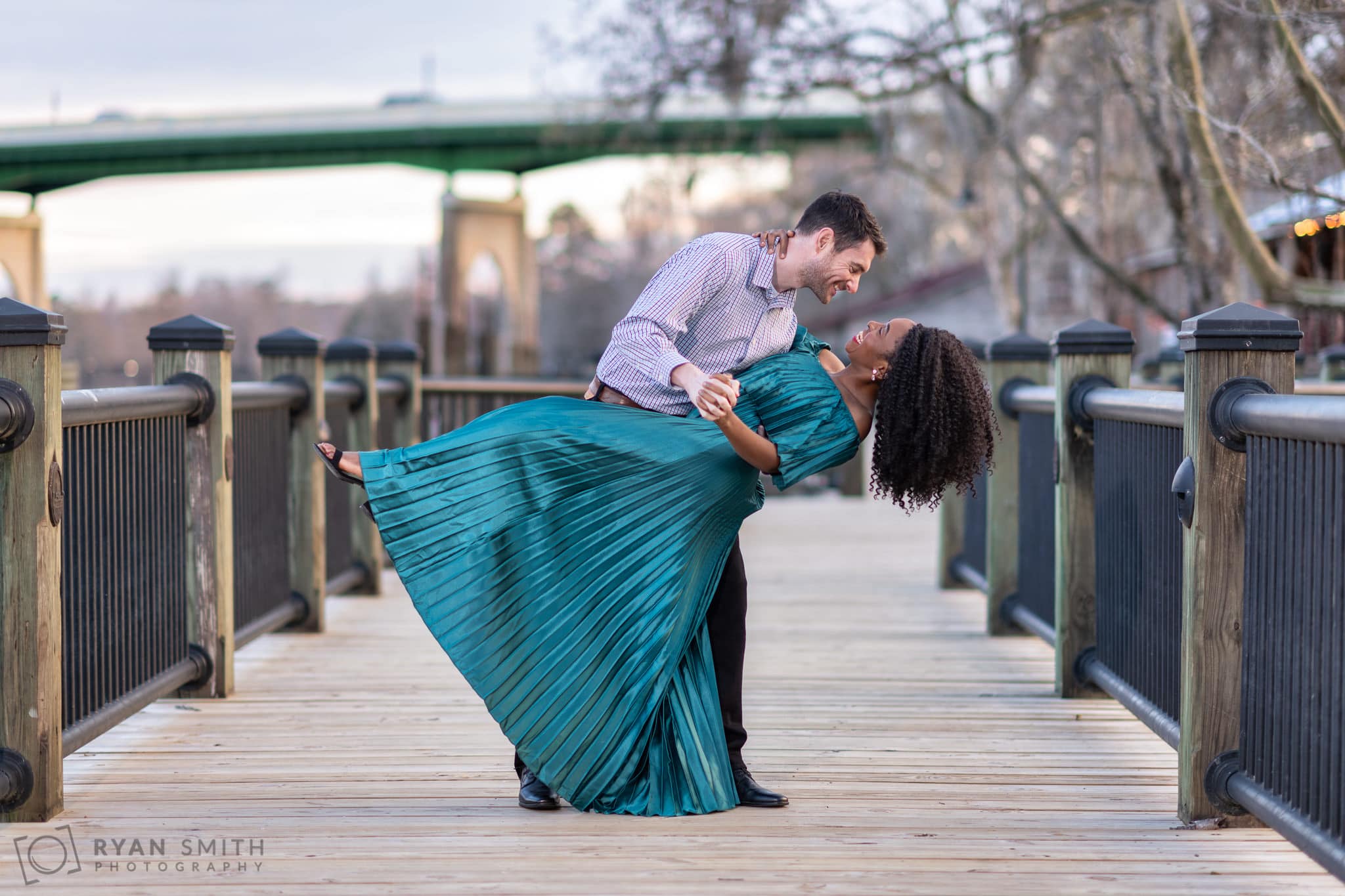 Husband and wife having fun with anniversary portraits - Conway Riverwalk