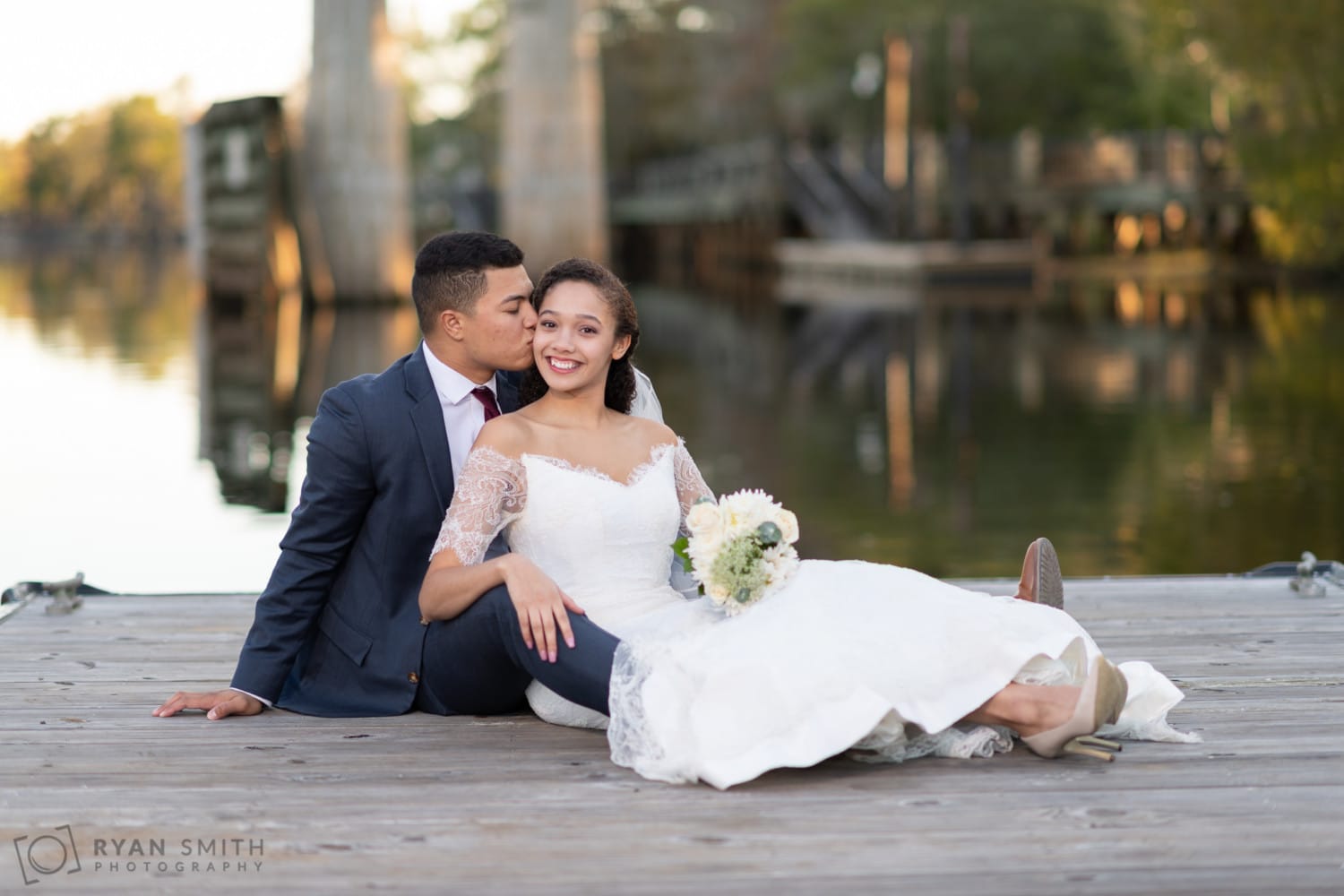 Husband and wife laying together on the dock on the Waccamaw River - Conway Riverwalk