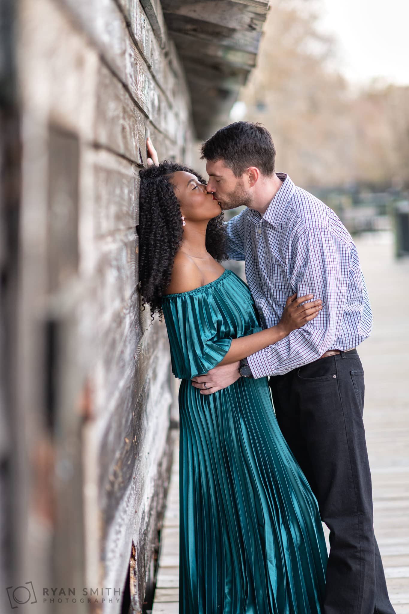 Kiss against the old wood wall - Conway Riverwalk