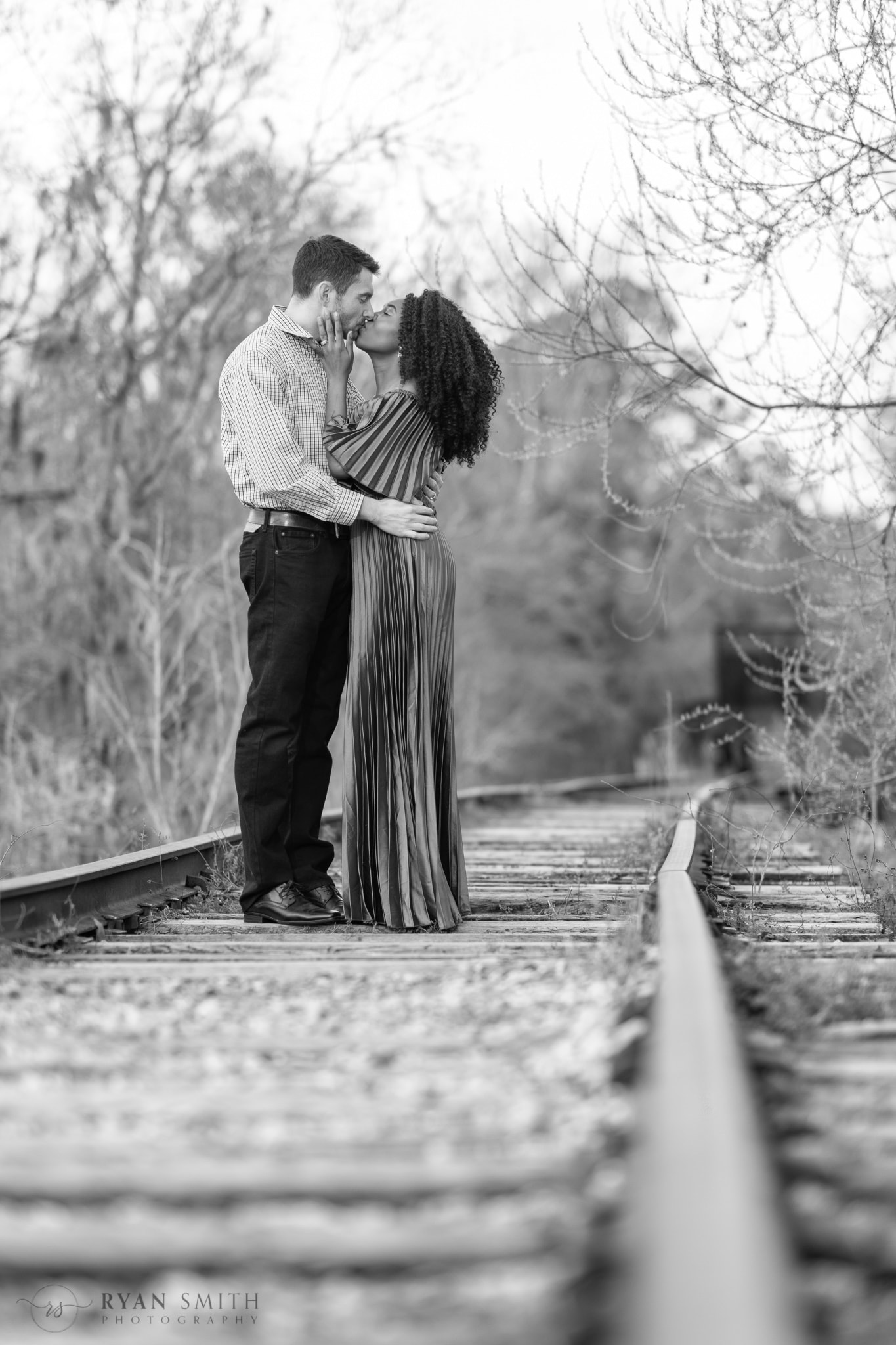 Kiss on the train tracks in black and white - Conway Riverwalk
