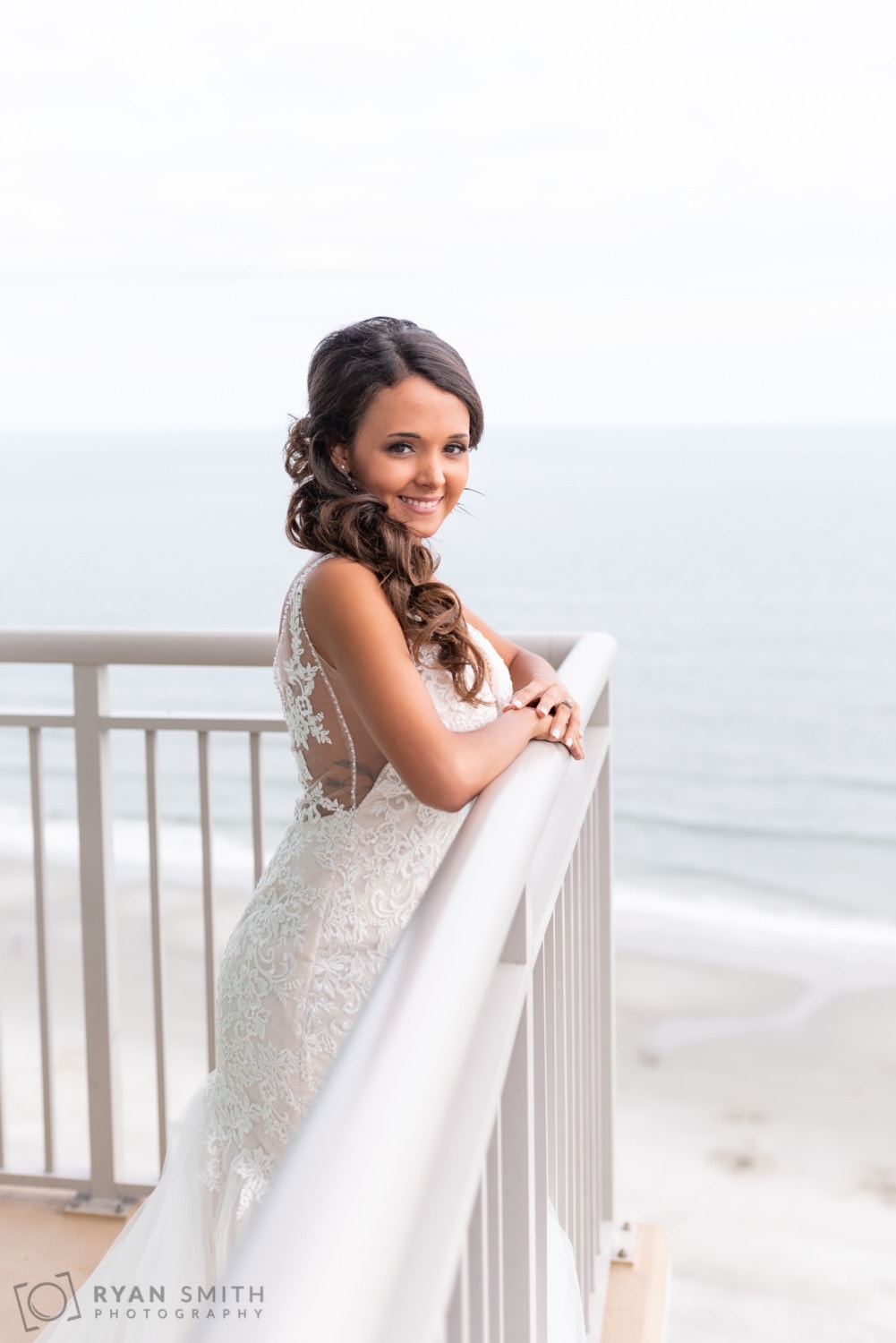 Leaning out over the balcony for a picture of the bride - Avista Resort - North Myrtle Beach