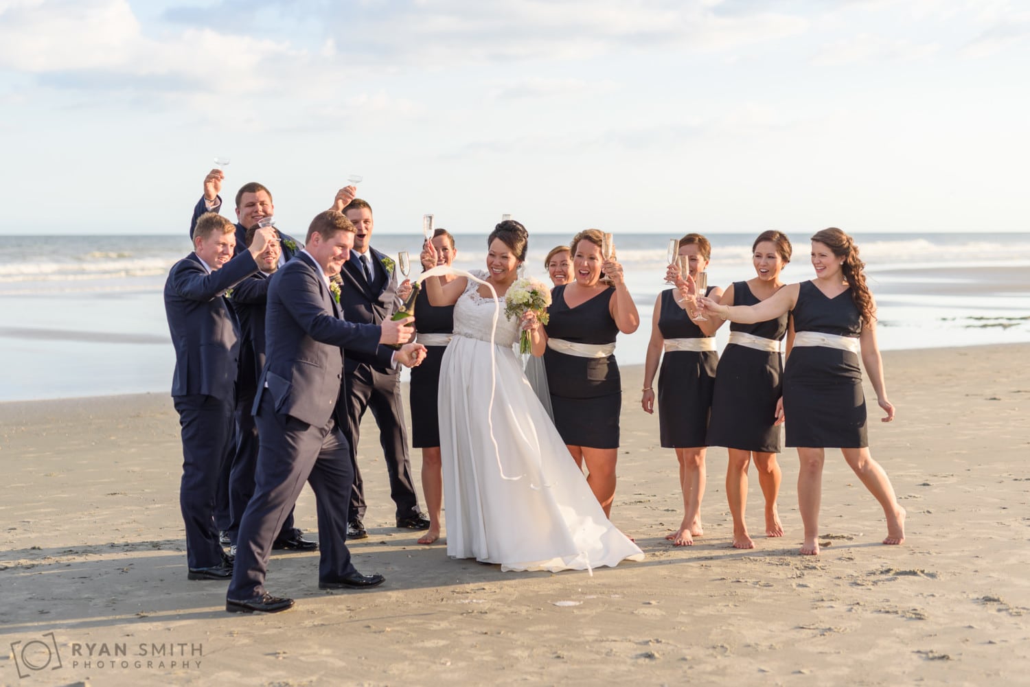 Popping the champagne cork on the beach - Dye Club at Barefoot Resort