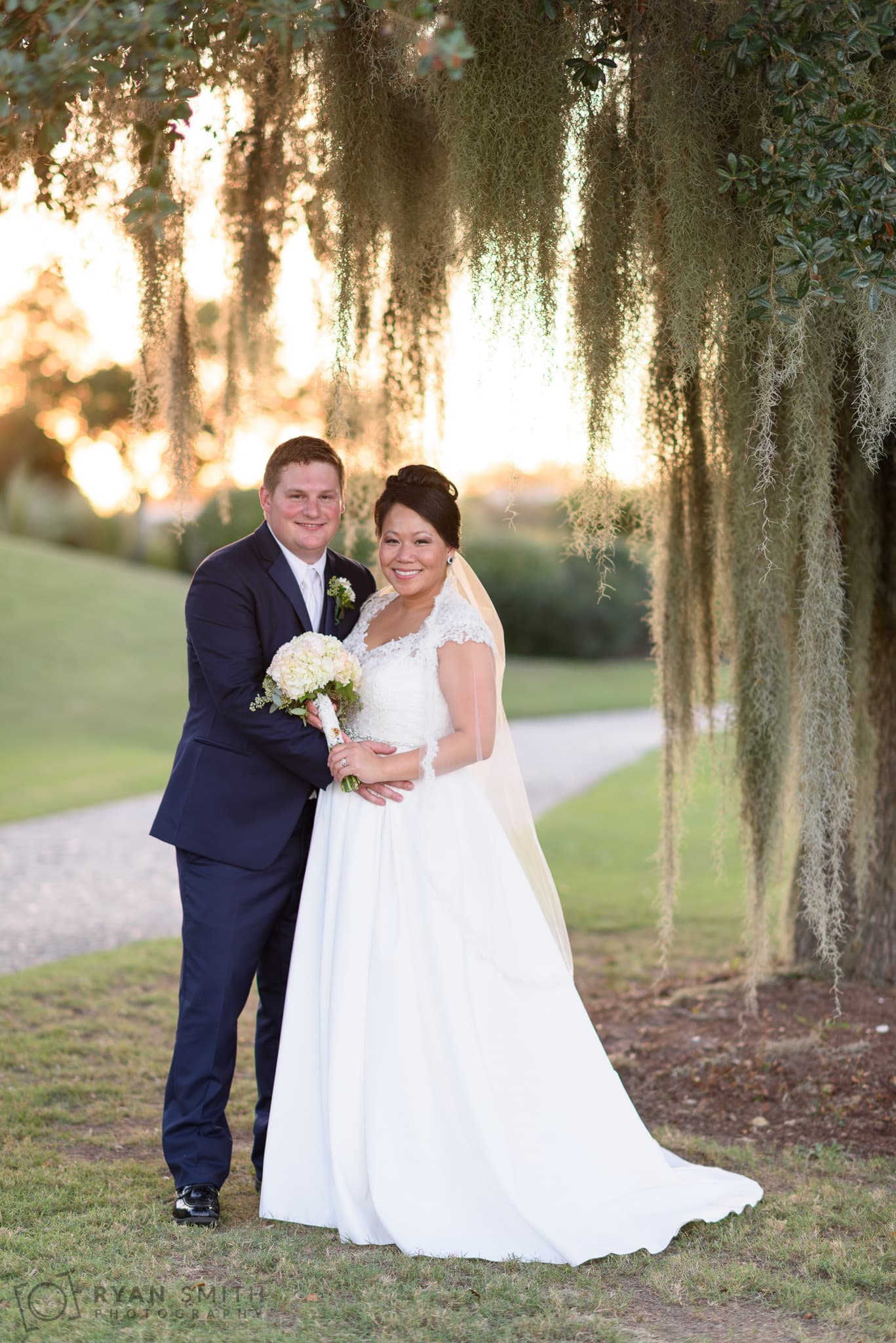 Portraits of the bride and groom under the tree moss - Dye Club at Barefoot Resort