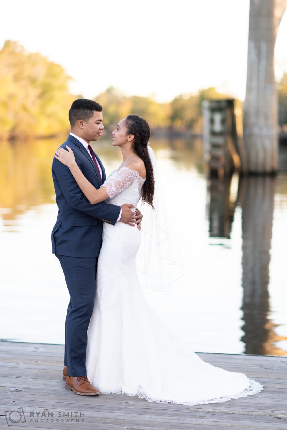 Romantic poses near the water on the riverwalk docks - Conway Riverwalk