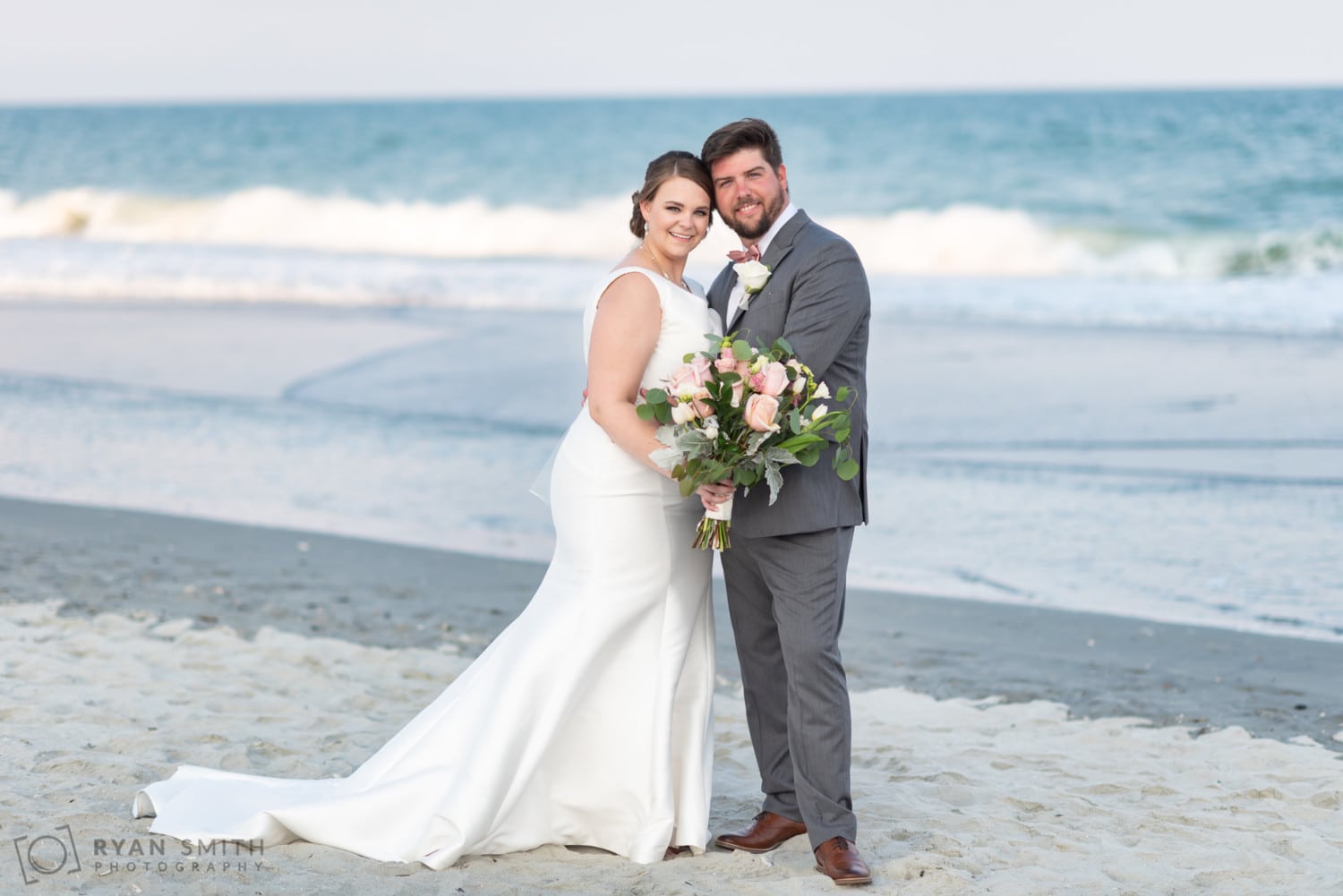 Bride and groom standing by the ocean - Grande Dunes Ocean Club - Myrtle Beach
