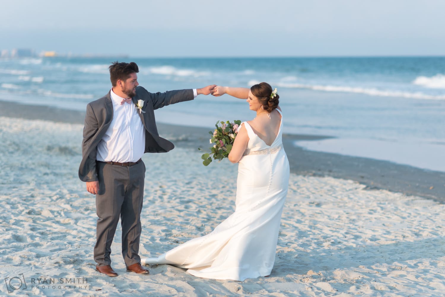 Bride and groom walking down the beach - Grande Dunes Ocean Club - Myrtle Beach