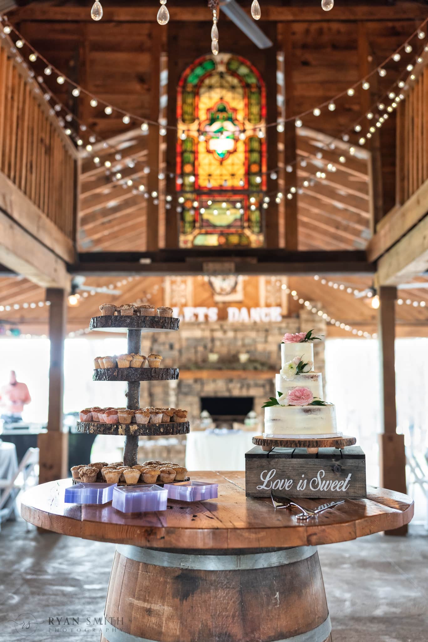 Detail picture of the cake table with stained glass window in the background - Wildhorse at Parker Farms