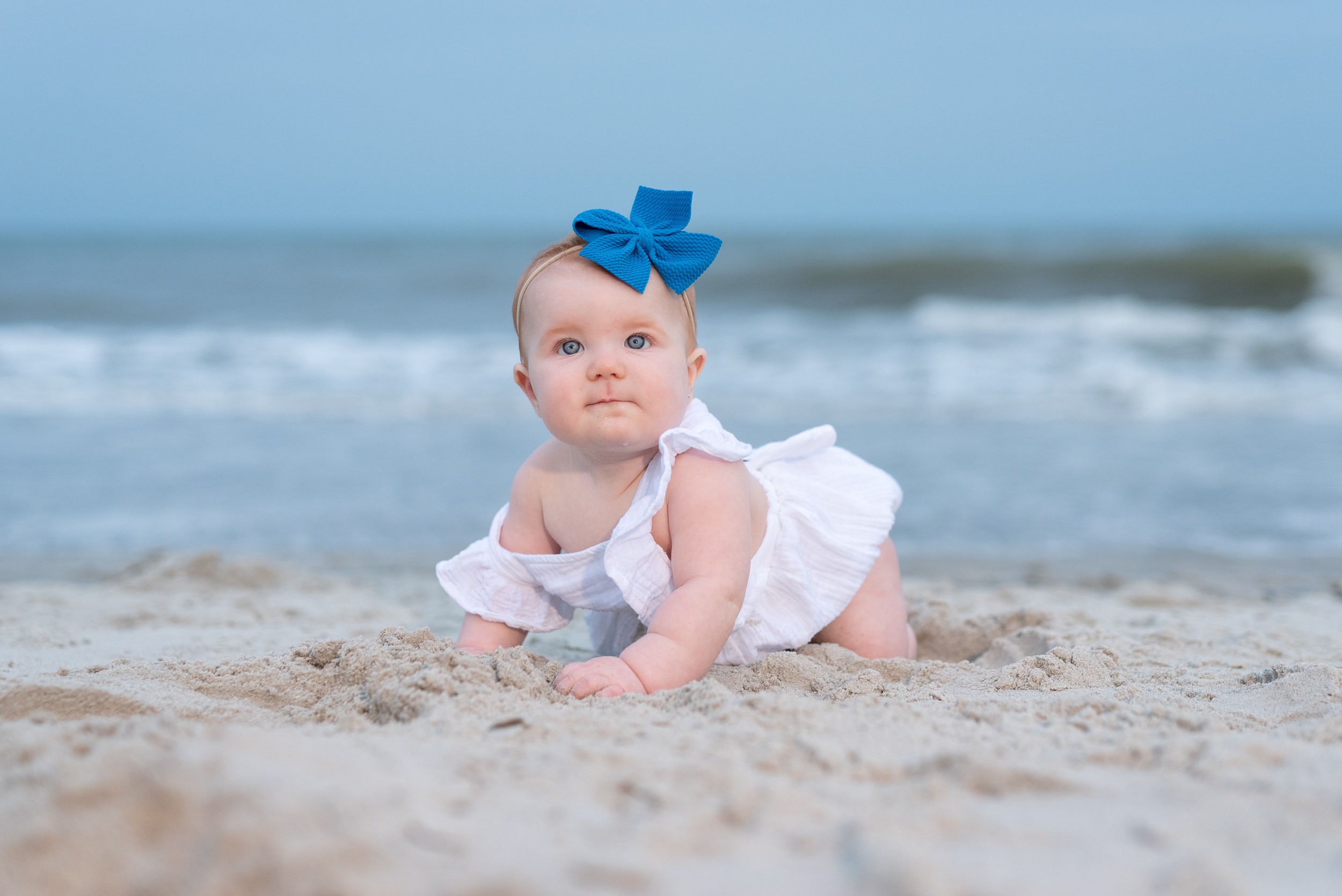 Baby girl in the sand in front of the ocean - Huntington Beach State Park