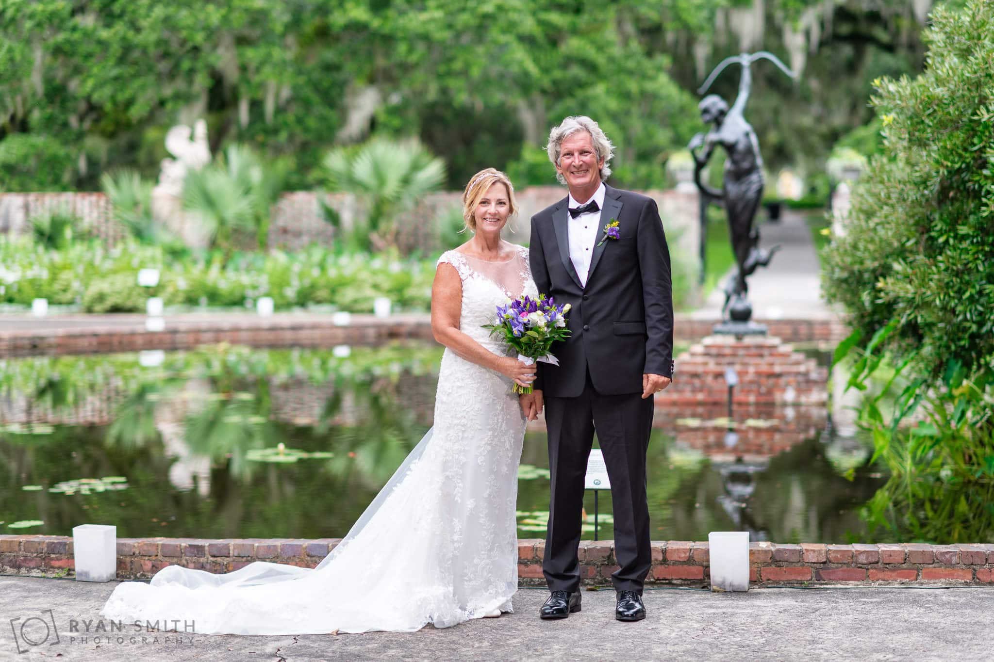 Bride and groom holding hands - Diana of the Chase Pool - Brookgreen Gardens
