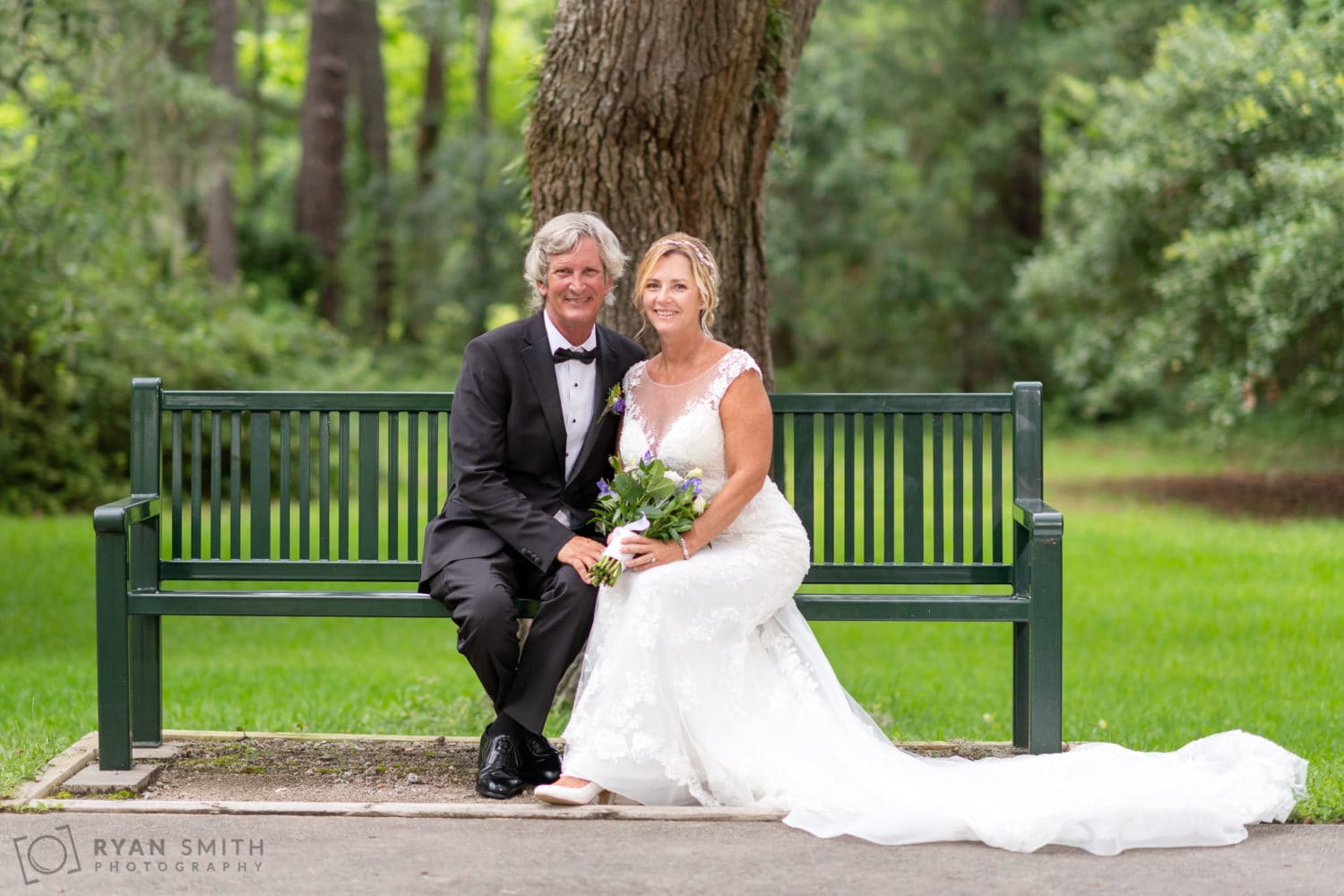 Bride and groom sitting on the park bench - Holiday Cottage - Brookgreen Gardens