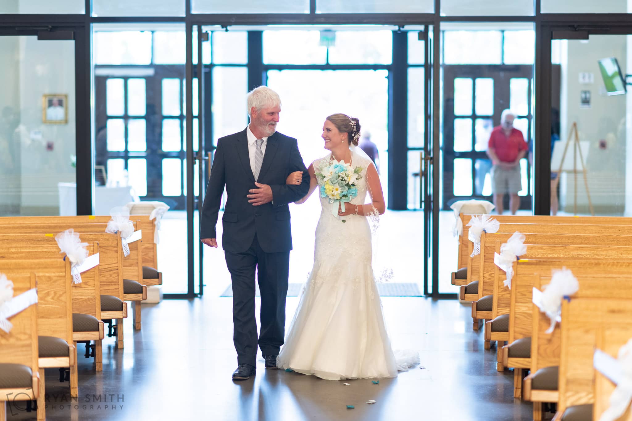 Bride and father looking at each other as they walk down the aisle  - St. Michael's - Garden City, SC
