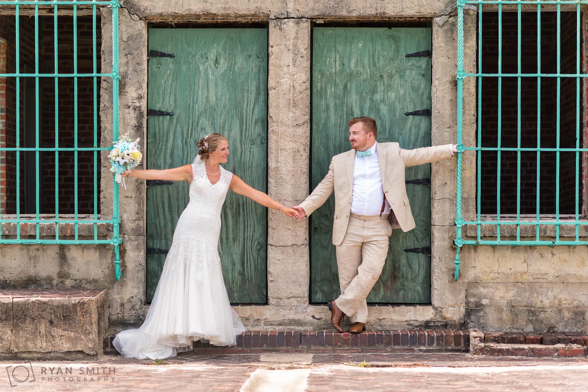 Bride and groom posing by the castle doors - Atalaya Castle - Huntington Beach State Park