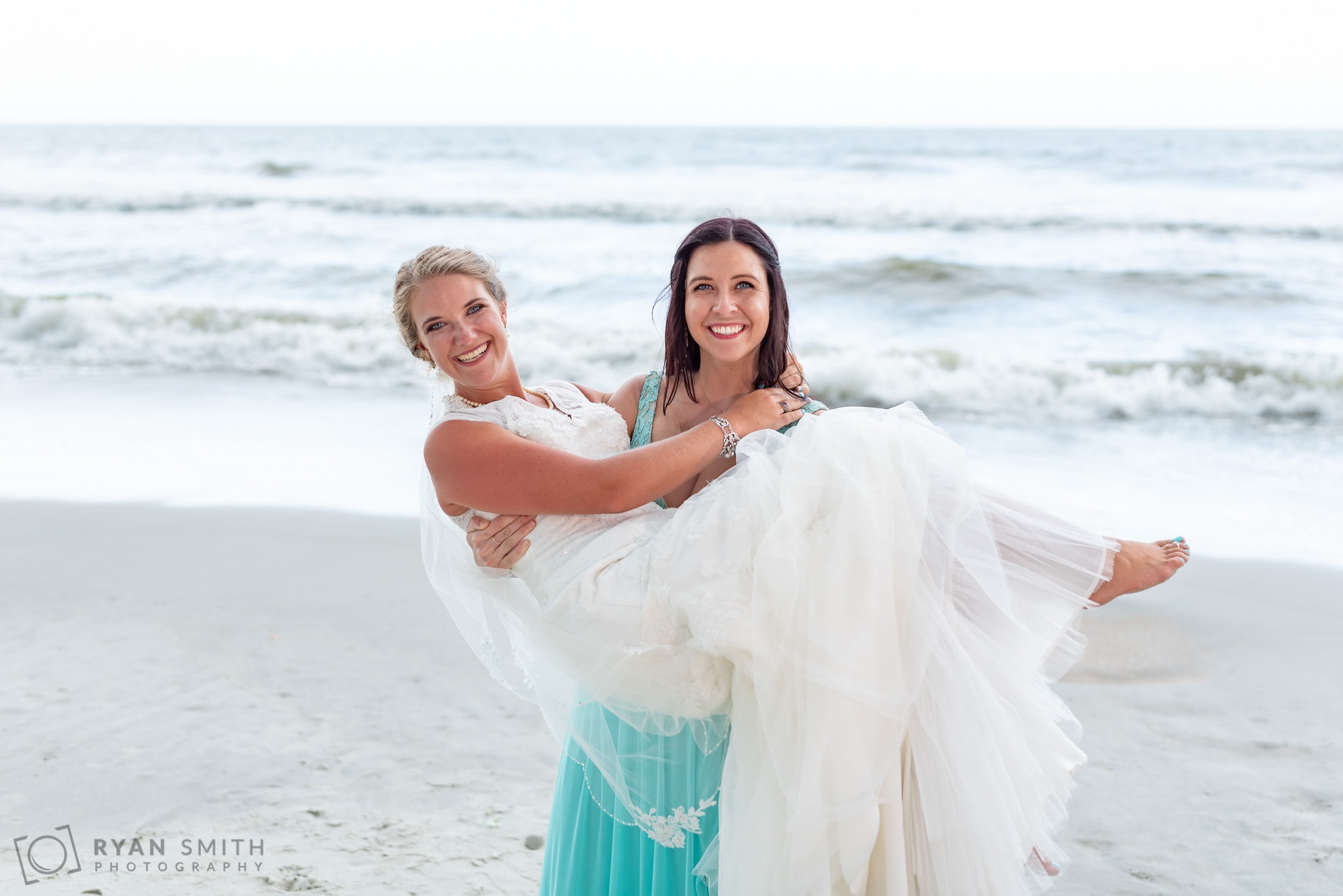 Bride being picked up by her sister - Atalaya Castle - Huntington Beach State Park