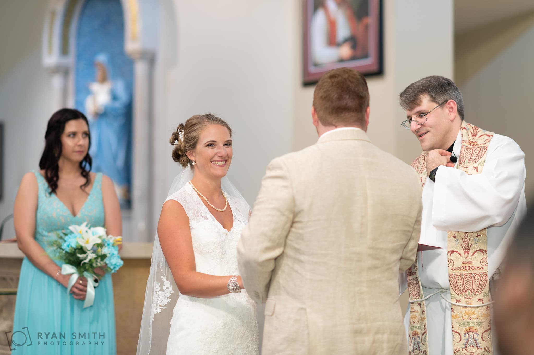 Bride smiling during the ceremony - St. Michael's - Garden City, SC