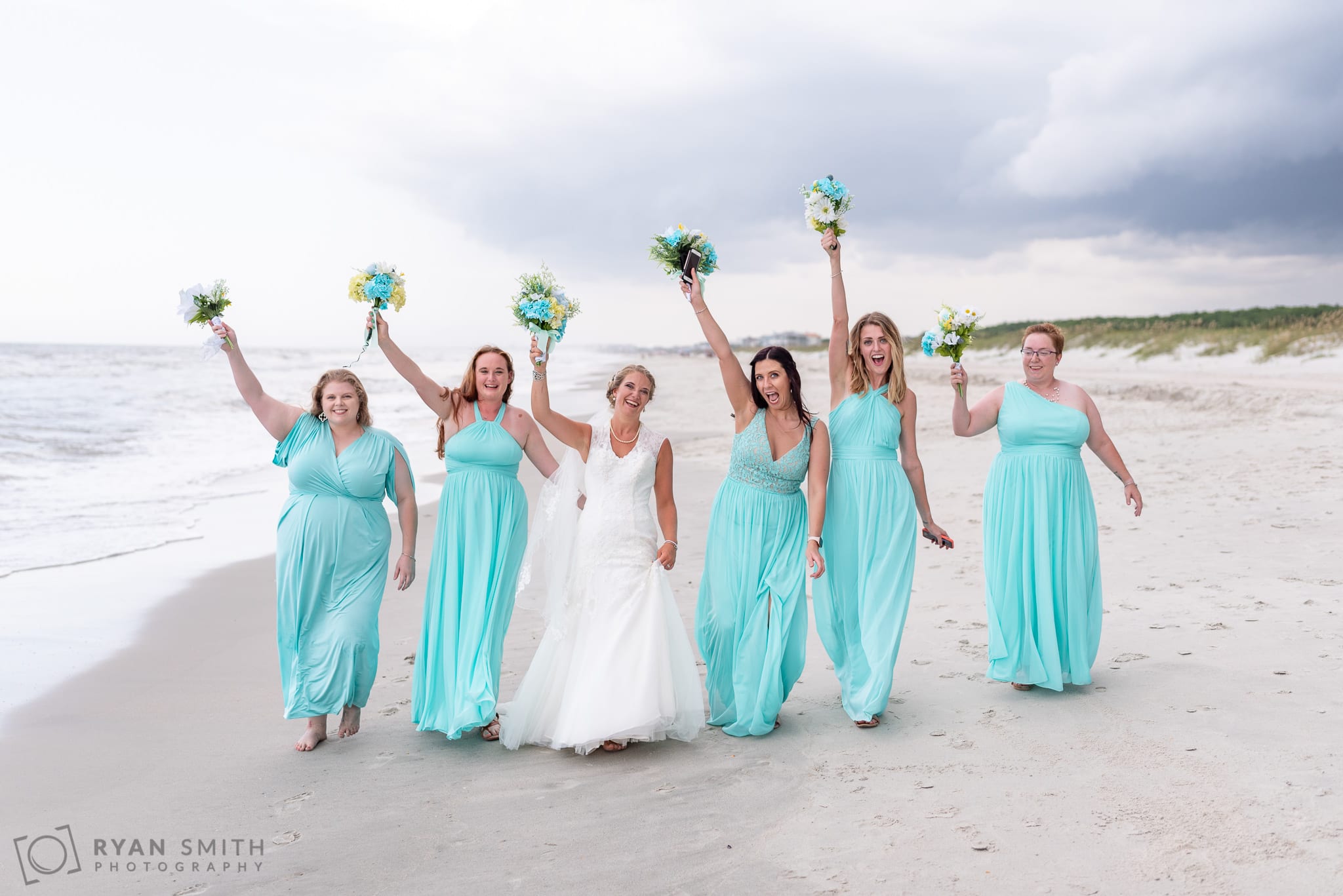 Bridesmaids walking together down the beach - Atalaya Castle - Huntington Beach State Park