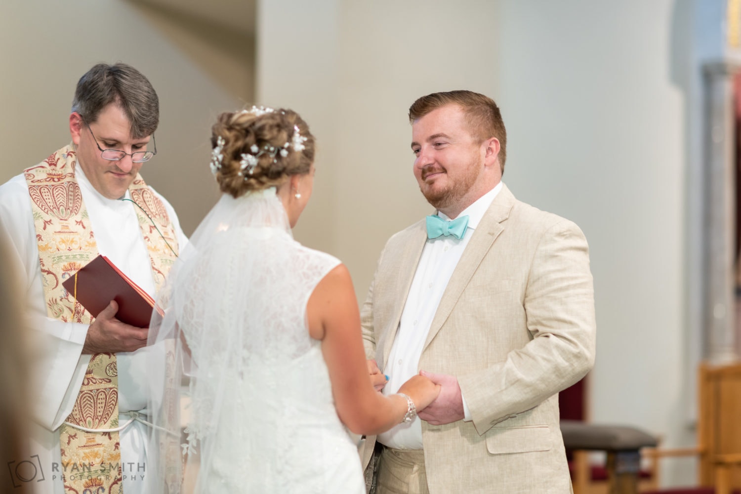Groom smiling at bride during vows - St. Michael's - Garden City, SC